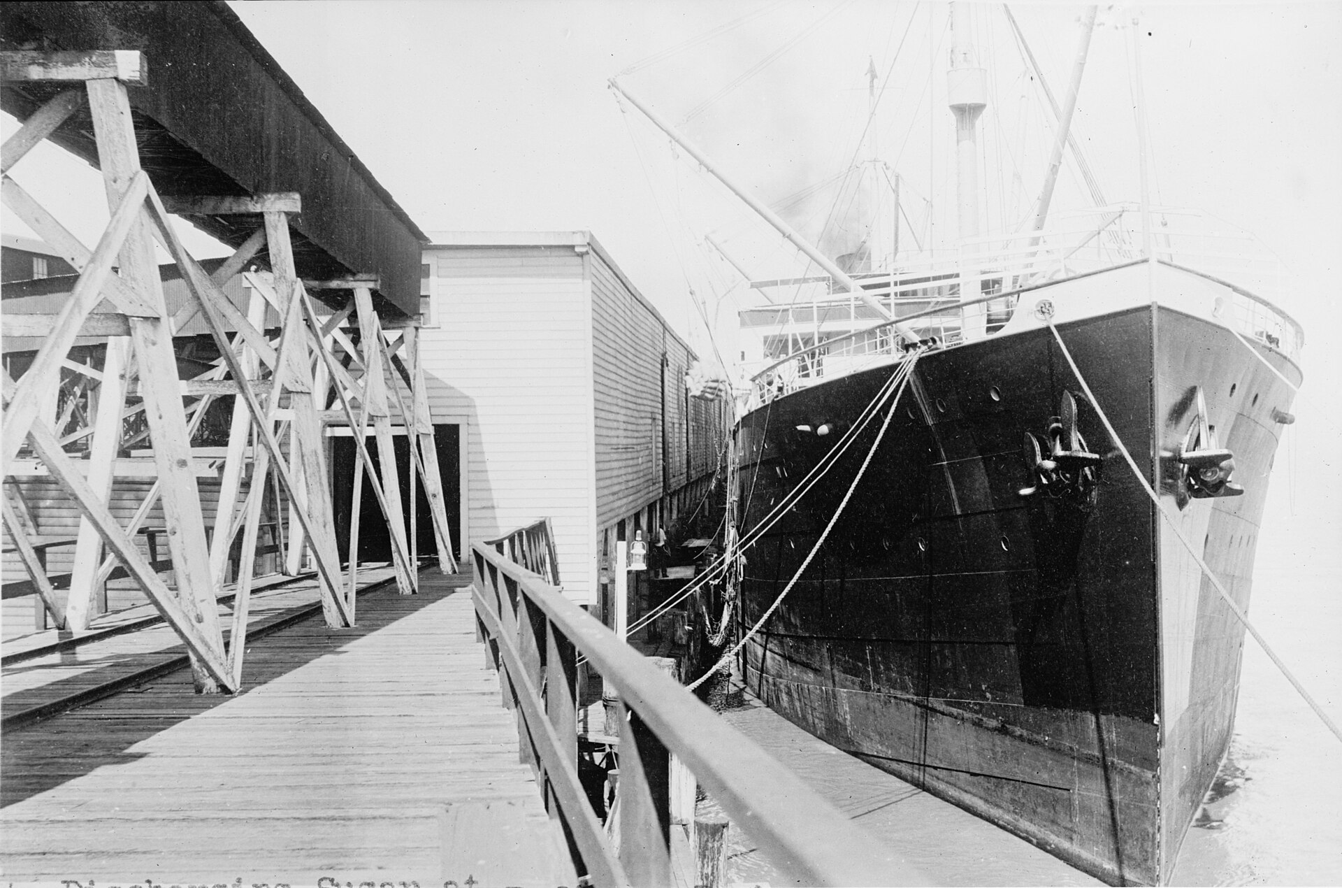 Historic photograph of a ship unloading sugar at the Crockett refinery dock