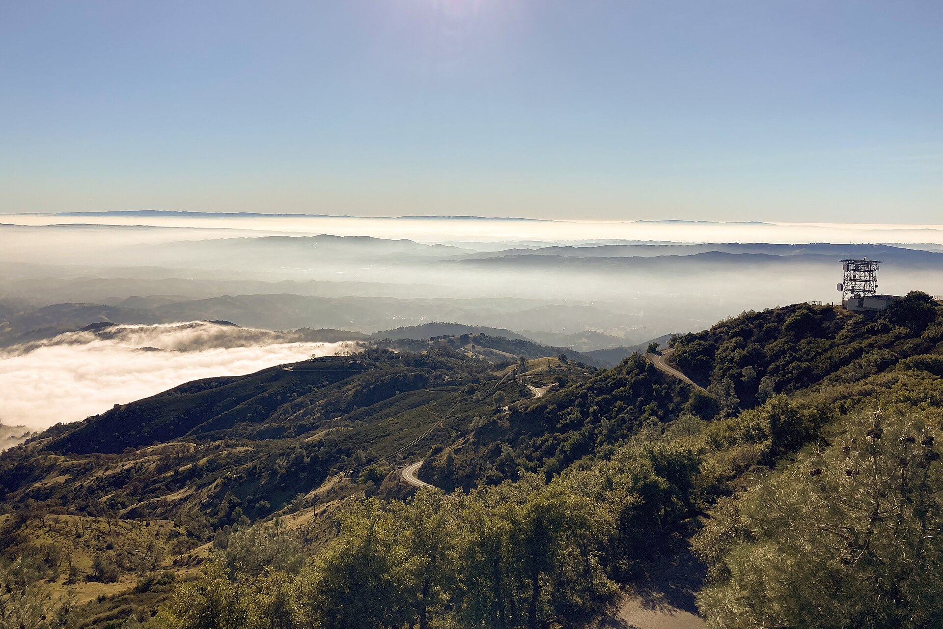 Mount Diablo's summit rising above a sea of fog with a lookout tower visible at right.