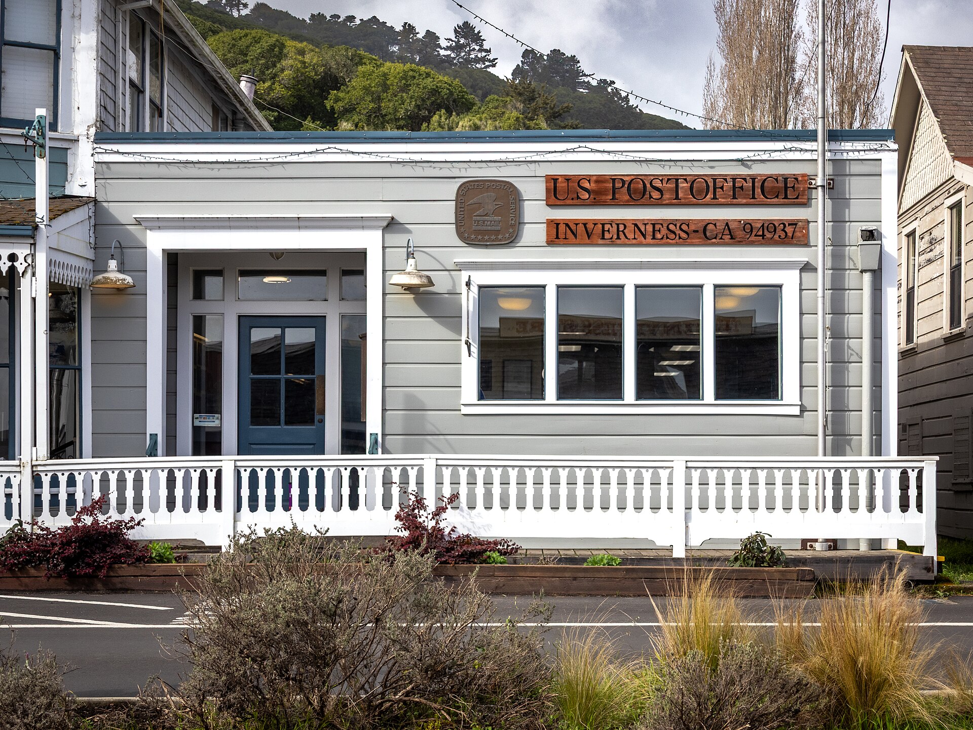 The U.S. Post Office in Inverness, a white clapboard building with a porch and a sign reading 'U.S. Post Office Inverness CA'.