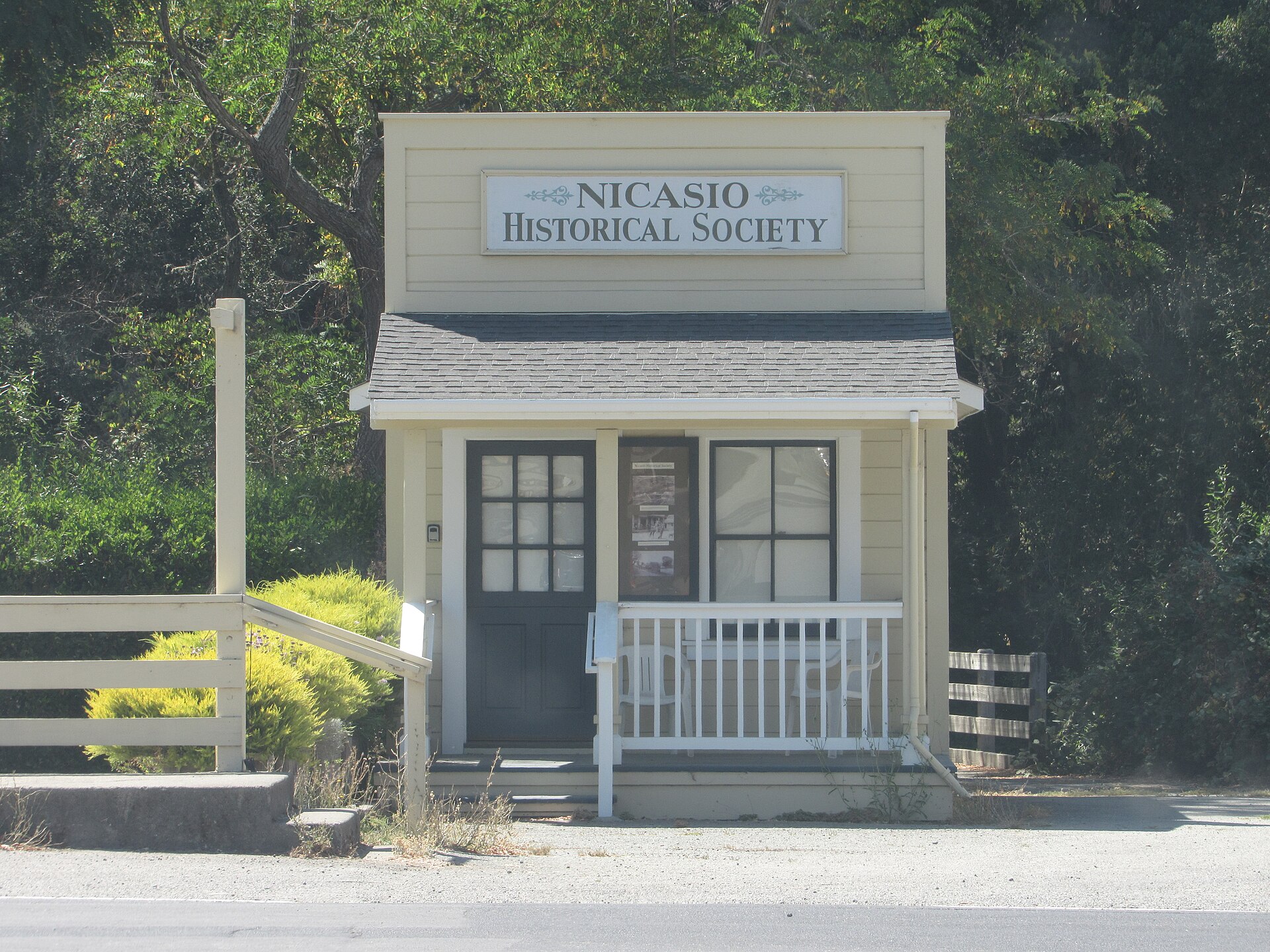 The Nicasio Historical Society building, a small white false-front structure with a sign above its porch.