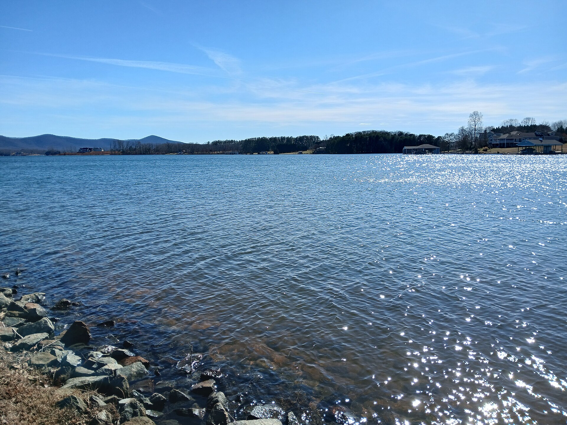 Smith Mountain Lake with wooded shoreline.