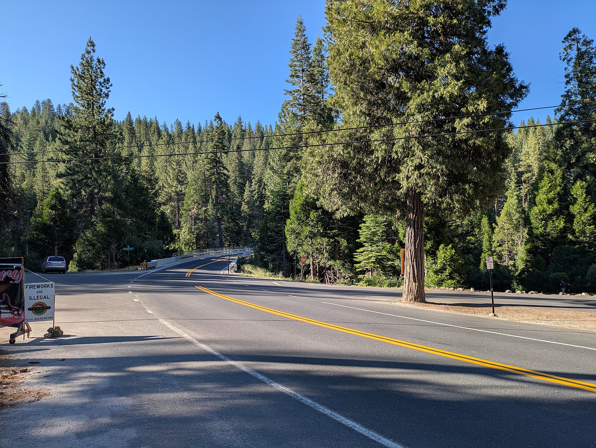 California State Route 108 passing through pine forest in Strawberry, California.