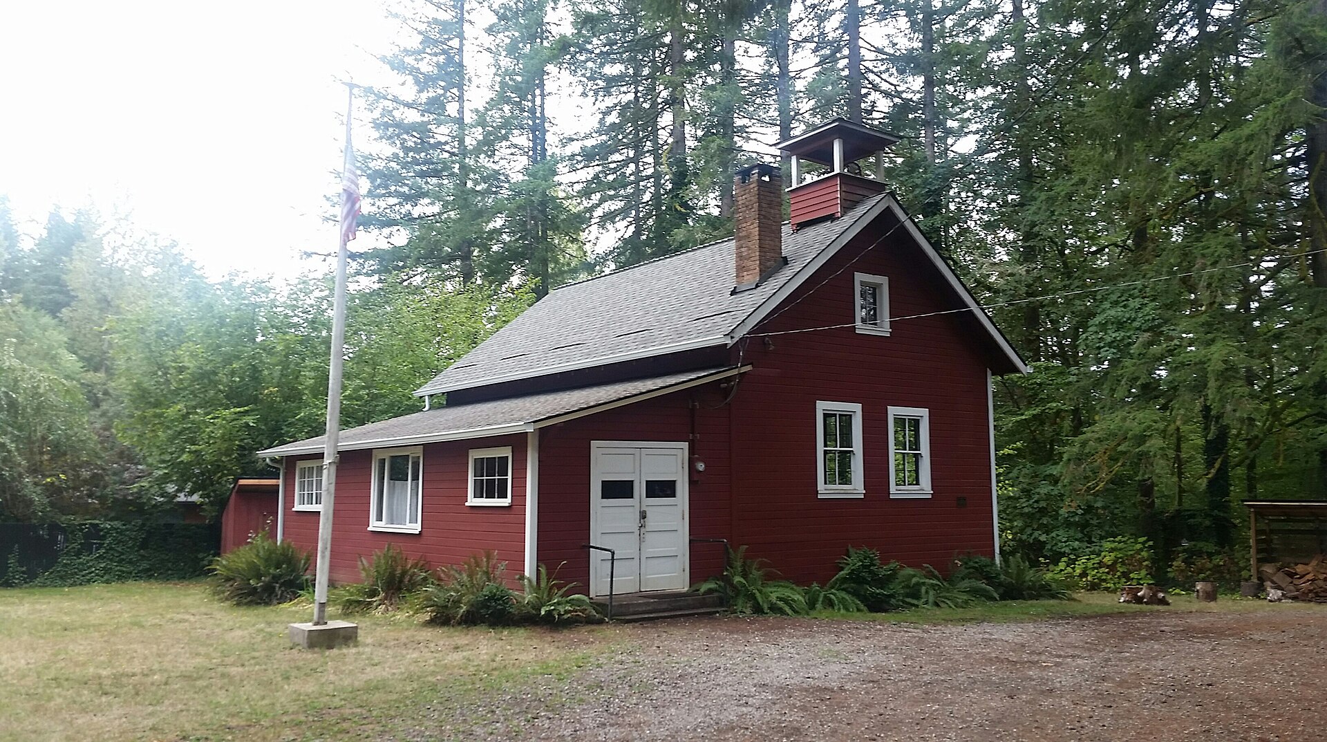The red Venersborg Schoolhouse on a cloudy day in Clark County, Washington.