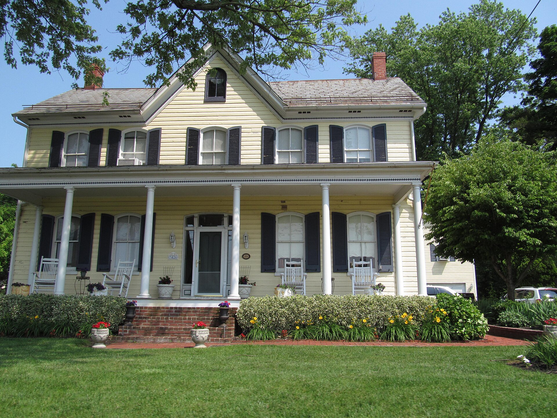 Historic yellow house with a porch in Buckeystown