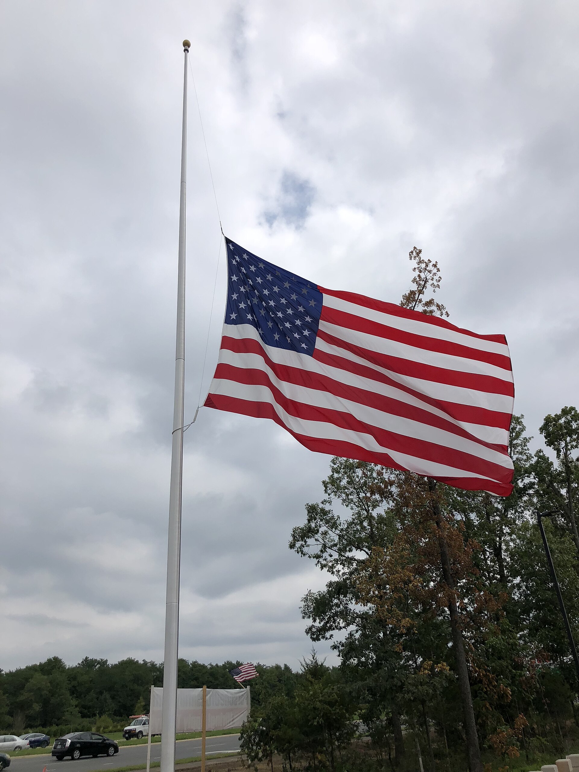 An American flag at half-staff along U.S. Route 50 in Chantilly