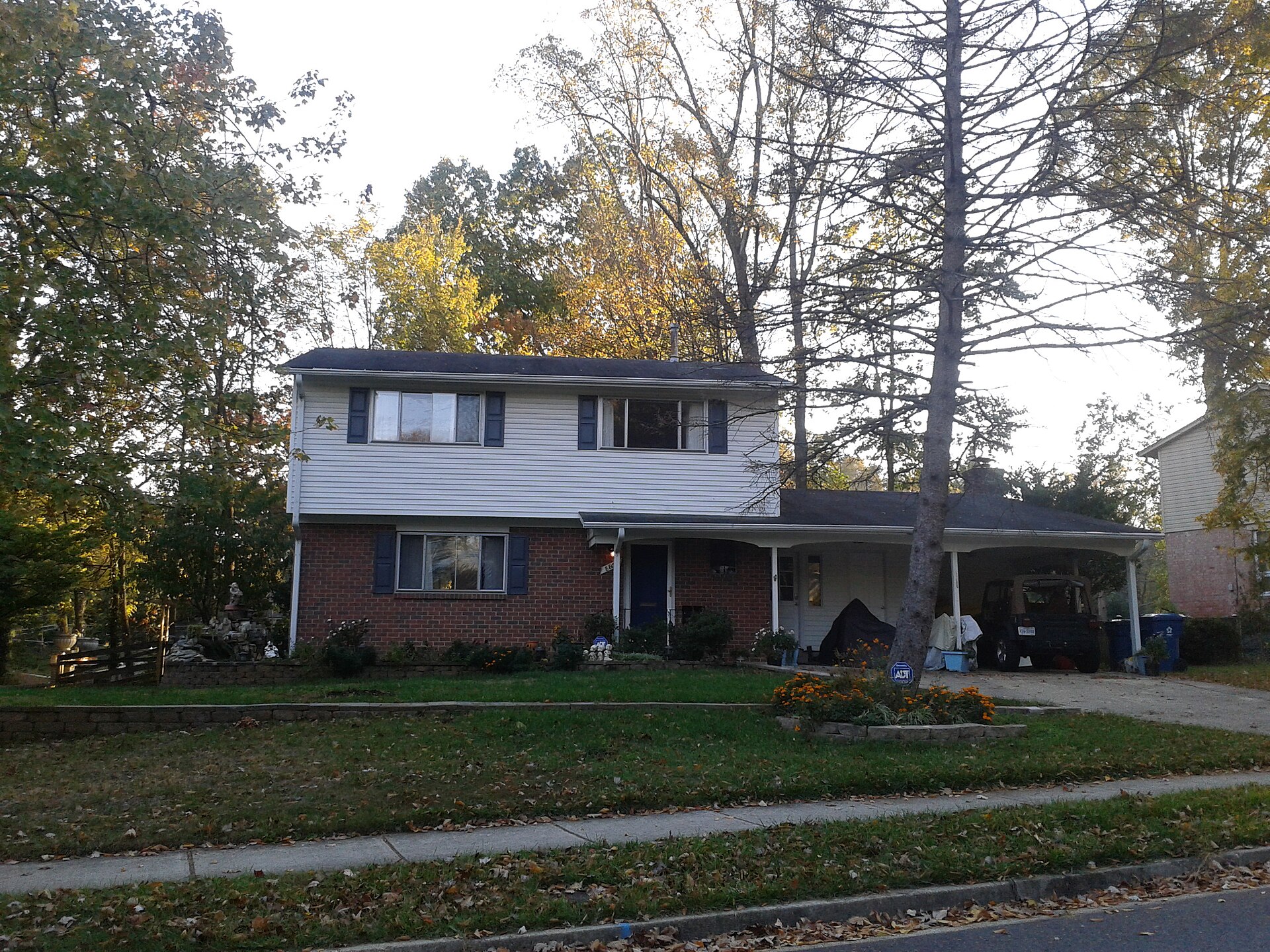 A two-story suburban house with a lawn in Kings Park, Virginia.