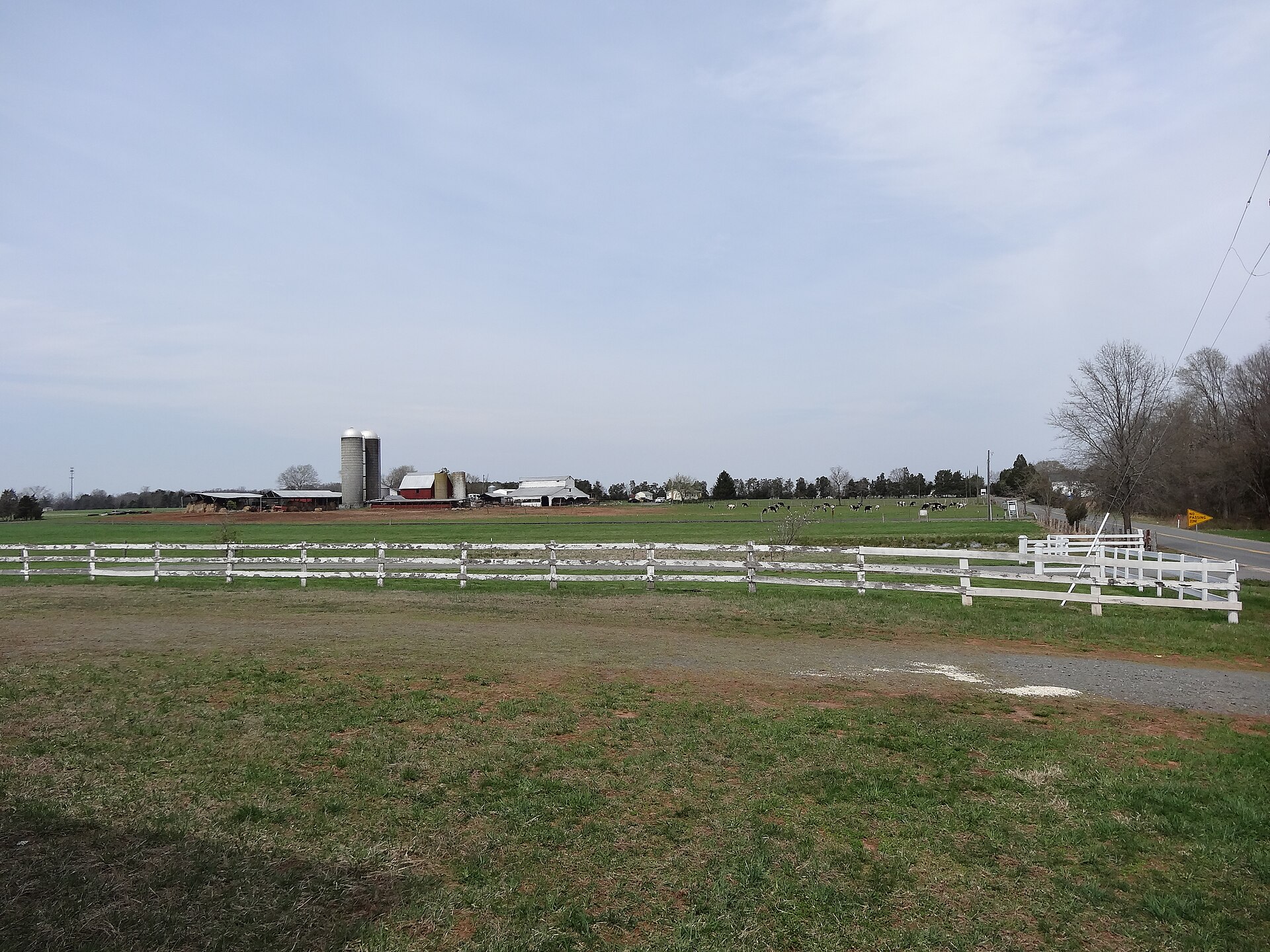 A farm with silos and white fencing on Fleetwood Drive in Nokesville, Virginia