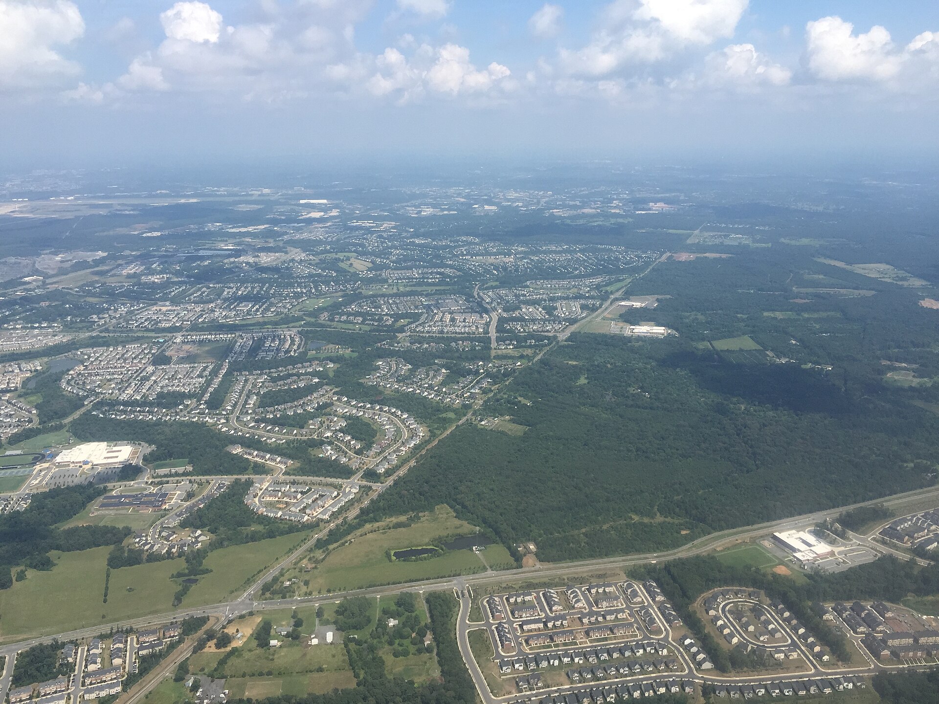 An aerial view of Stone Ridge and South Riding in Loudoun County, Virginia, showing subdivisions and green corridors.