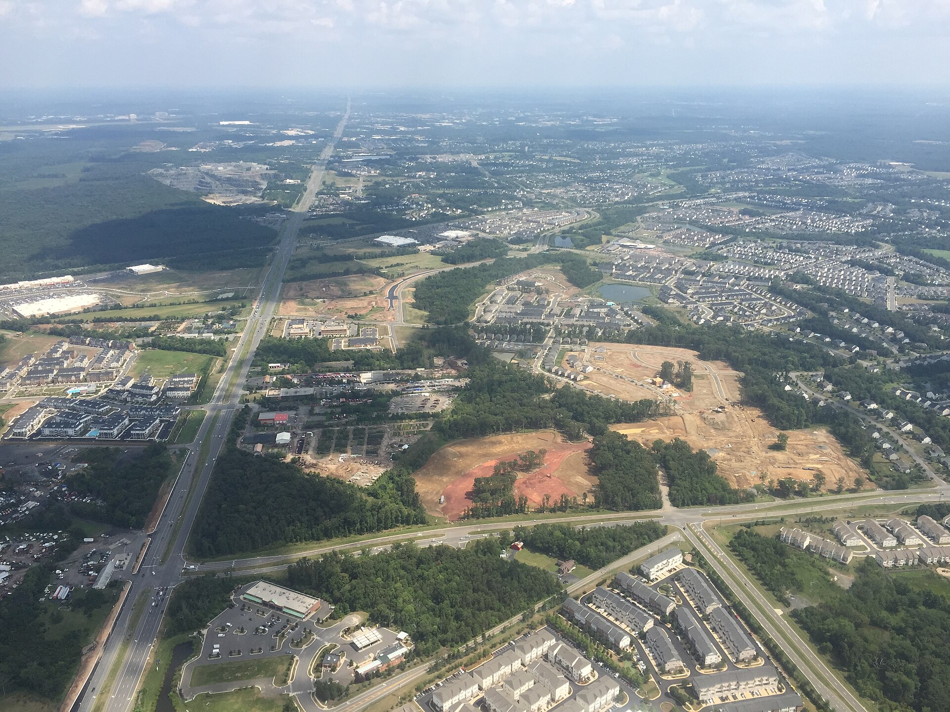 An aerial view along U.S. Route 50 through Stone Ridge, Virginia, with surrounding development.