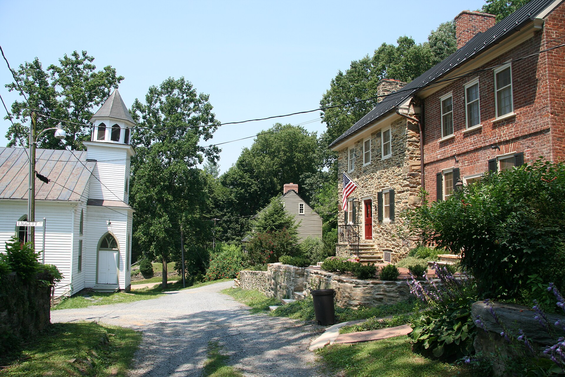 Liggett Street in Waterford, Virginia, lined with historic stone and brick buildings.