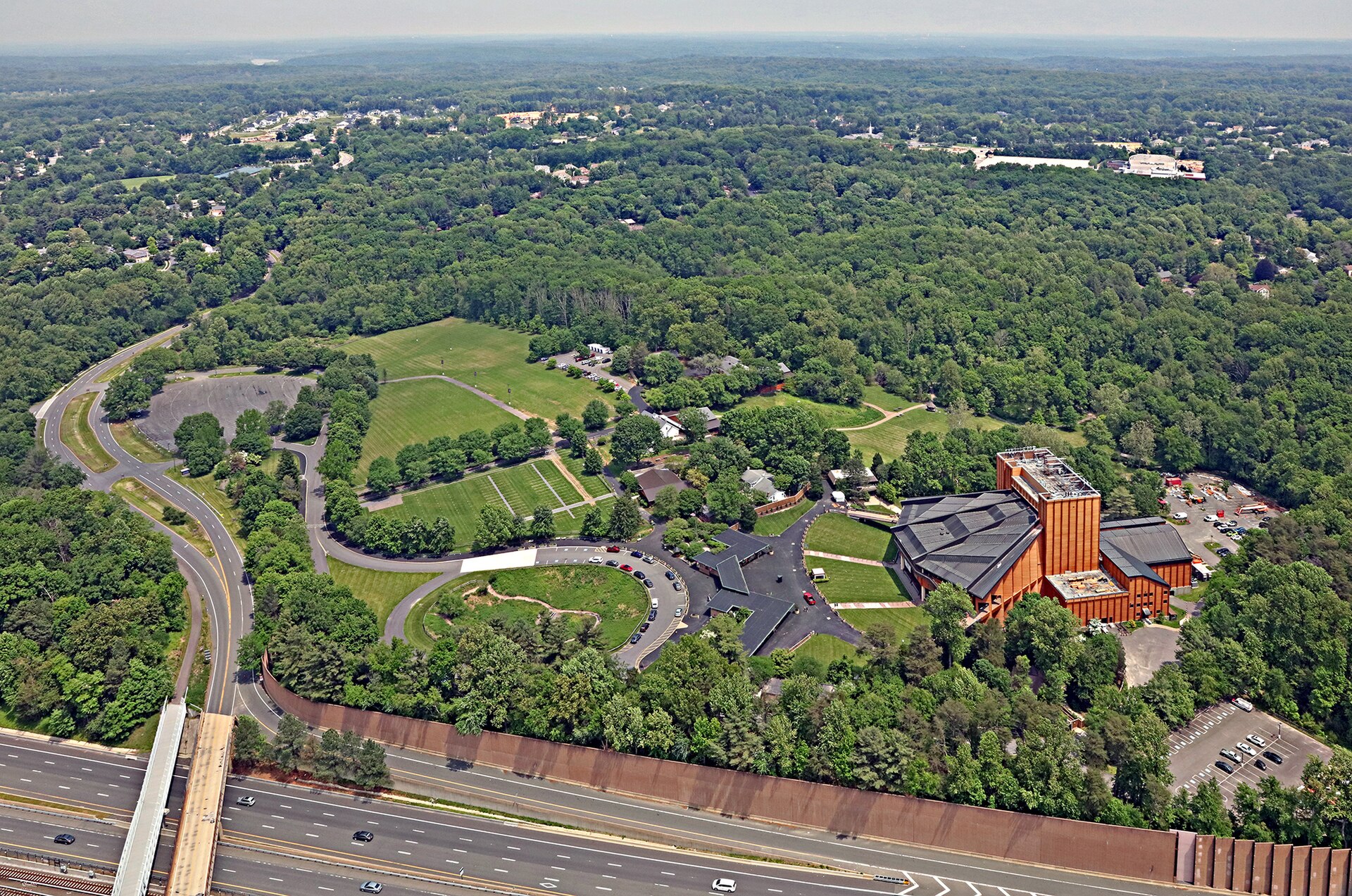 An aerial view of Wolf Trap National Park for the Performing Arts, with the Filene Center and Barns nestled in the woods.