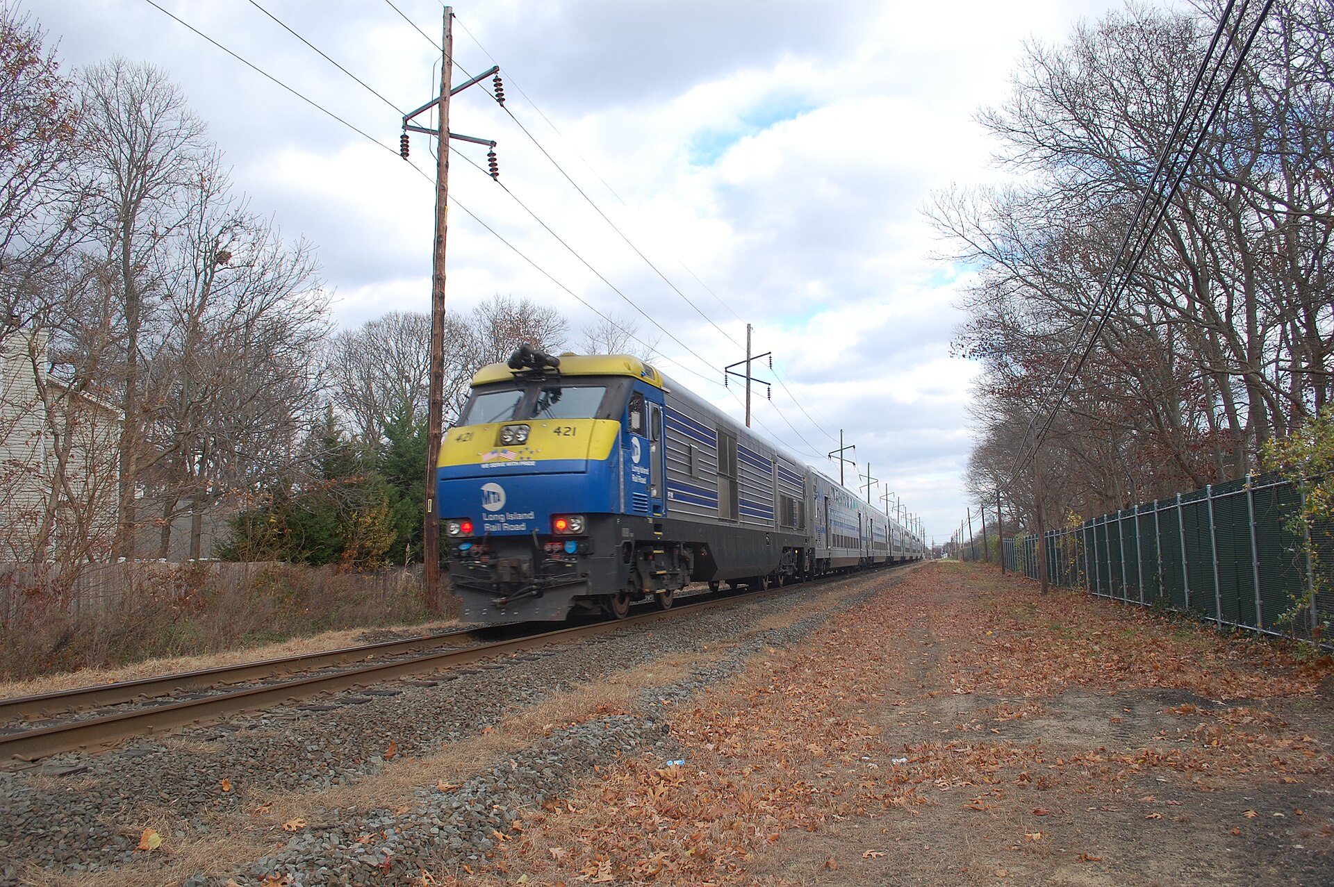 An LIRR diesel train passing the site of the former Bayport station in Bayport, New York.