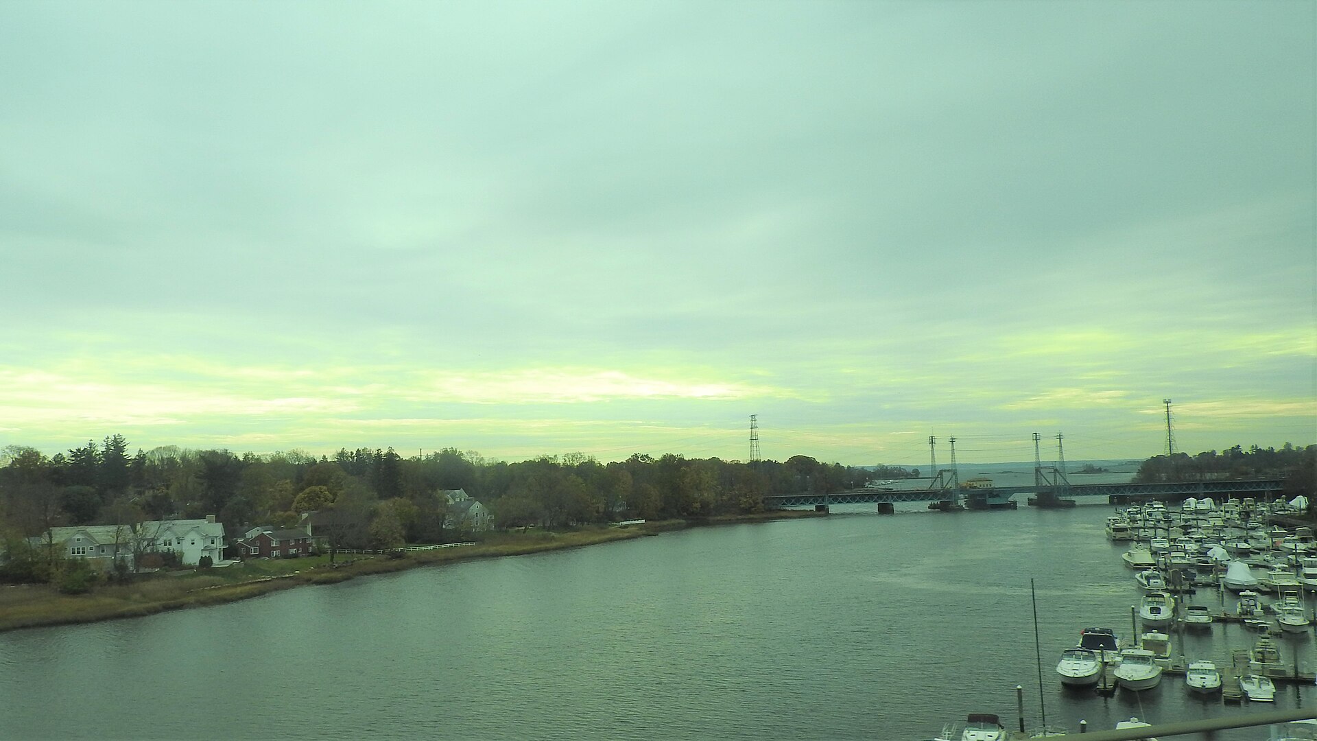 Cos Cob Harbor in Greenwich with sailboats moored, seen from I-95.