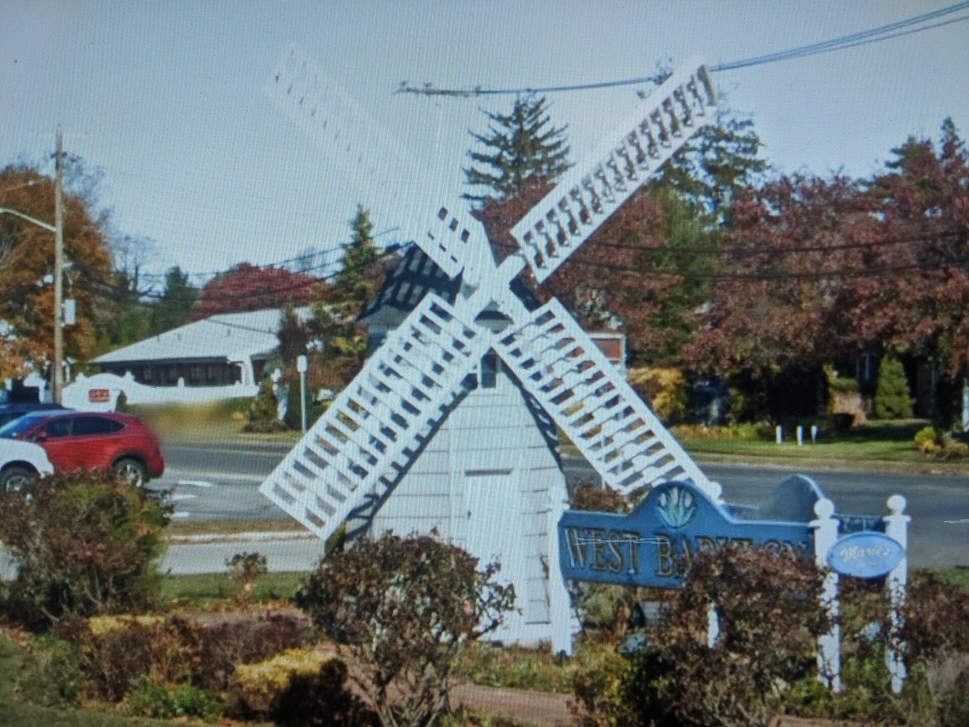 A windmill-shaped sign welcoming visitors to West Babylon New York.