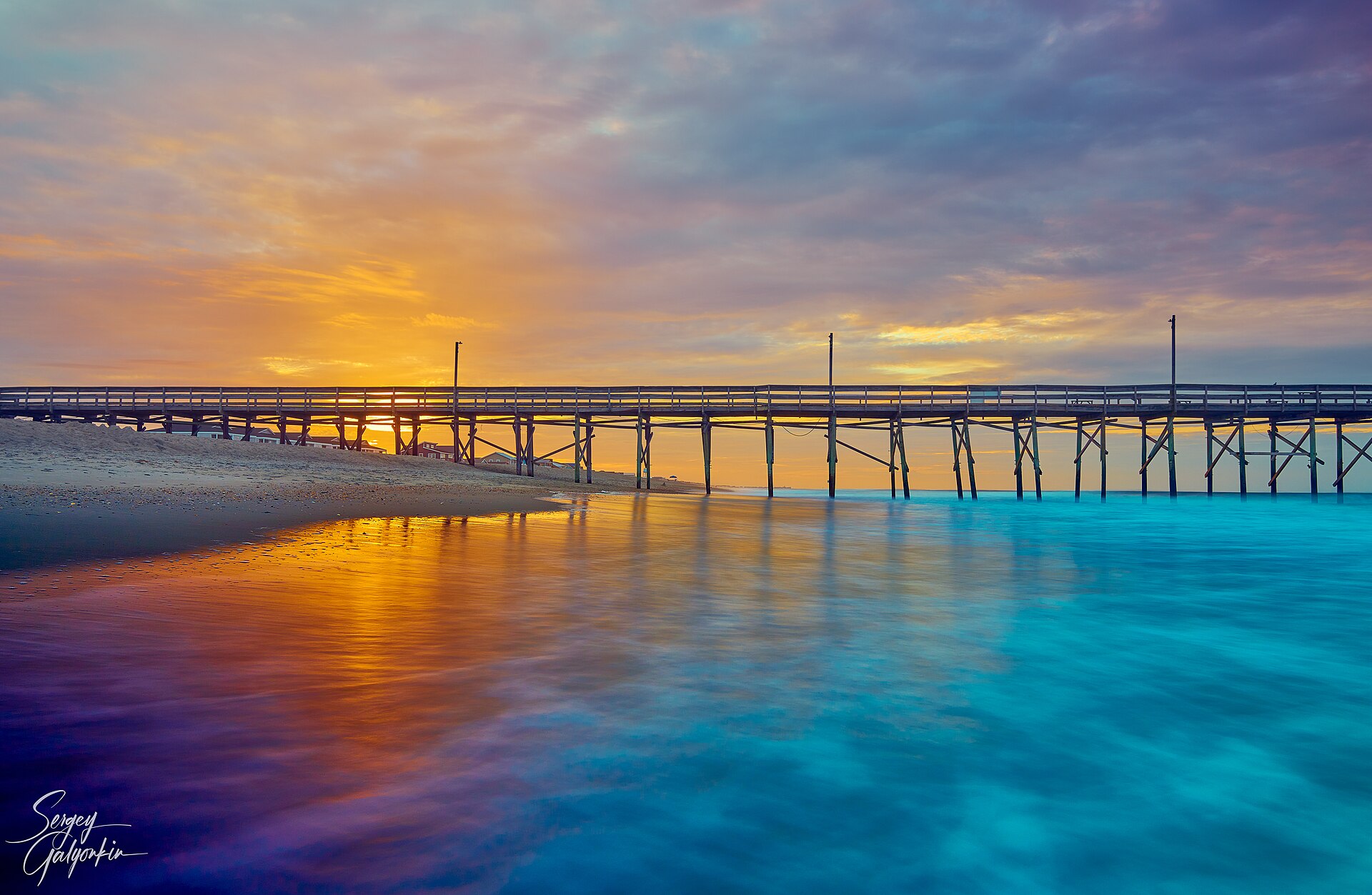 The Holden Beach pier at dawn over the Atlantic Ocean