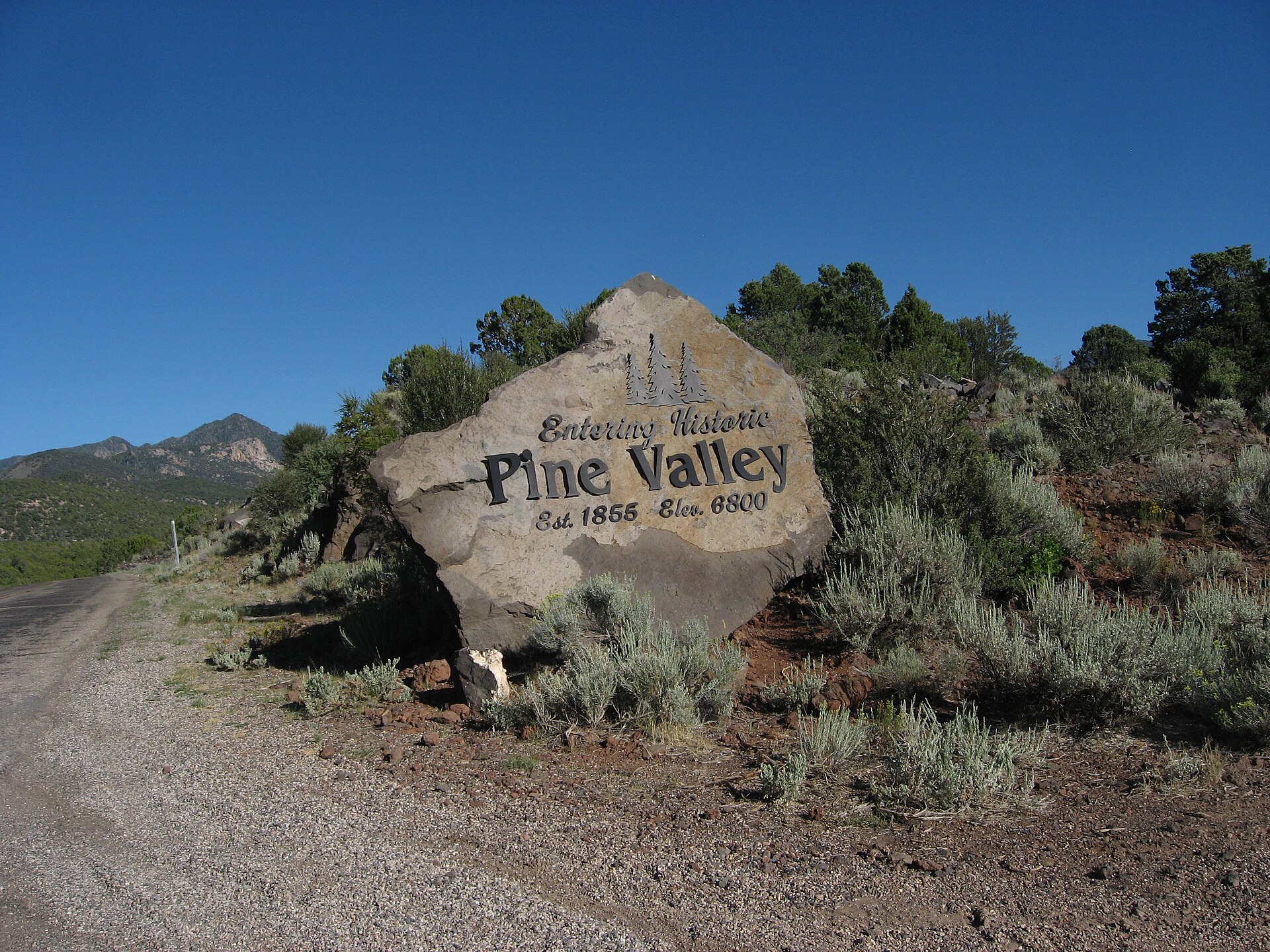 The "Entering Historic Pine Valley, Est. 1855, Elev. 6800" boulder sign