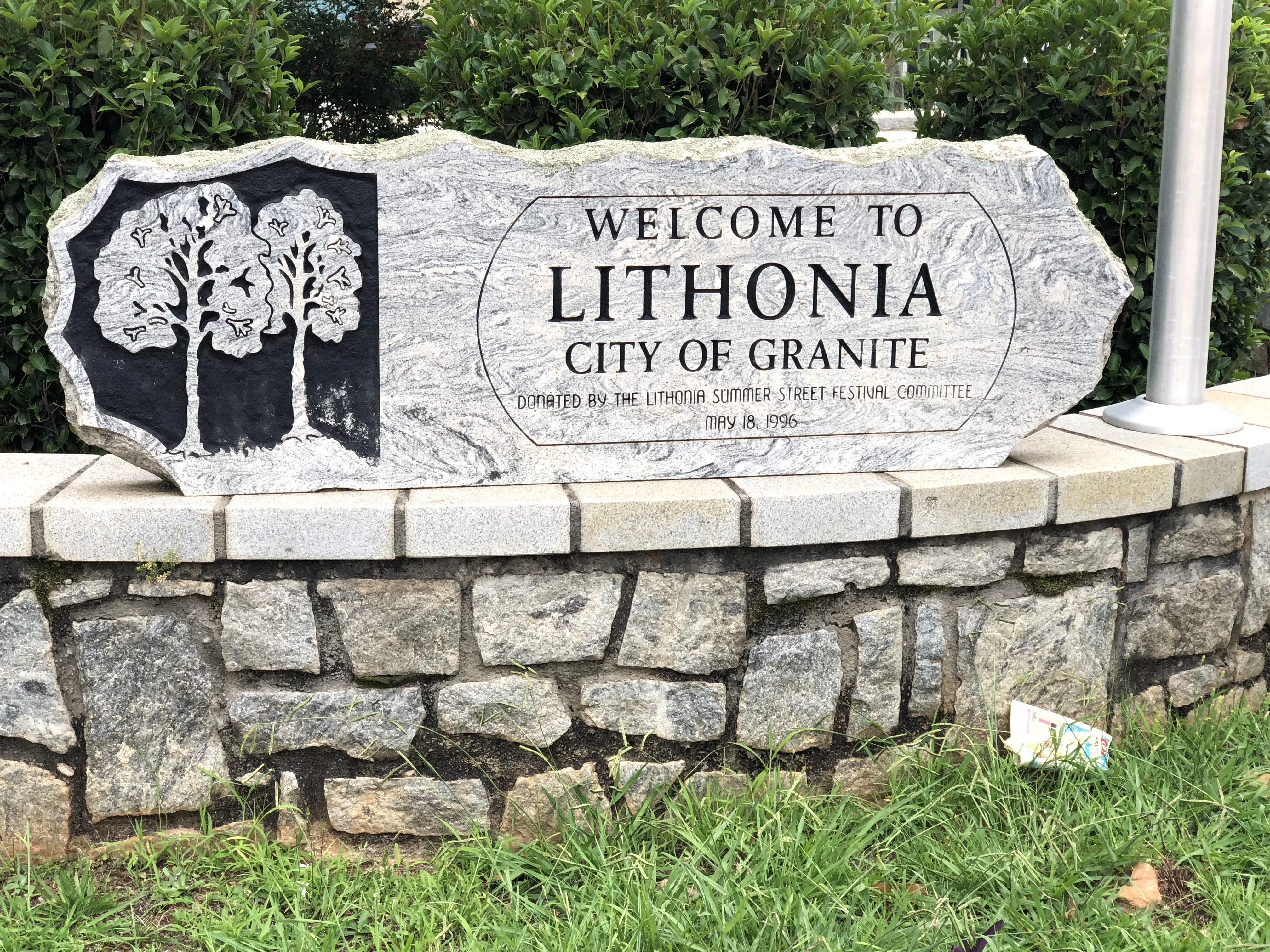 Granite sign at the corner of Main Street and Max Cleland Boulevard in downtown Lithonia, Georgia welcoming visitors to the town