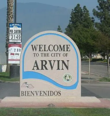 "Welcome to the city of Arvin." Sign in a convenience store parking lot at the entrance to Arvin, California.