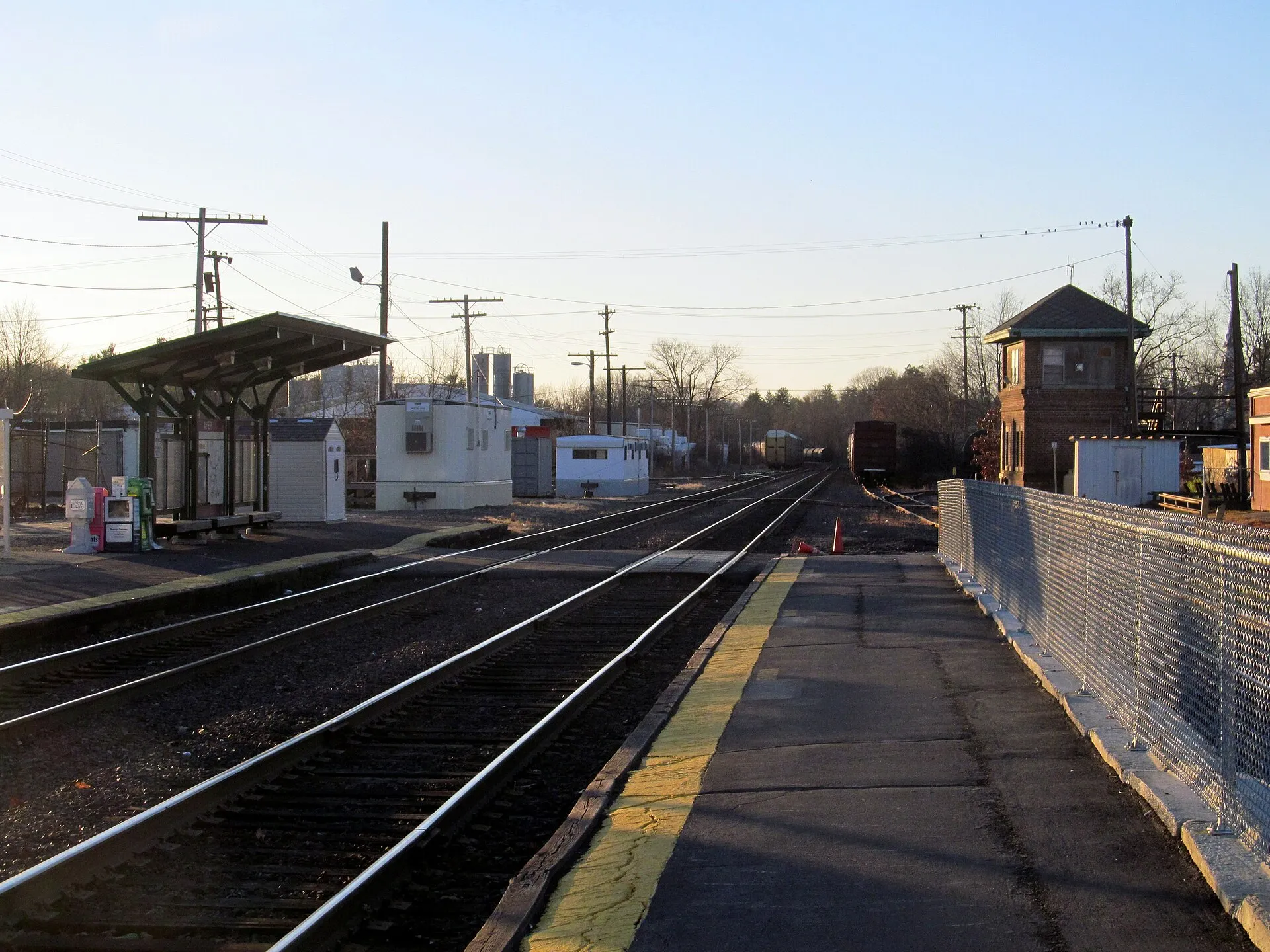 Outbound platform at Ayer station, facing outbound towards Fitchburg. The inbound platform is at left, and the interlocking tower in the distance.
