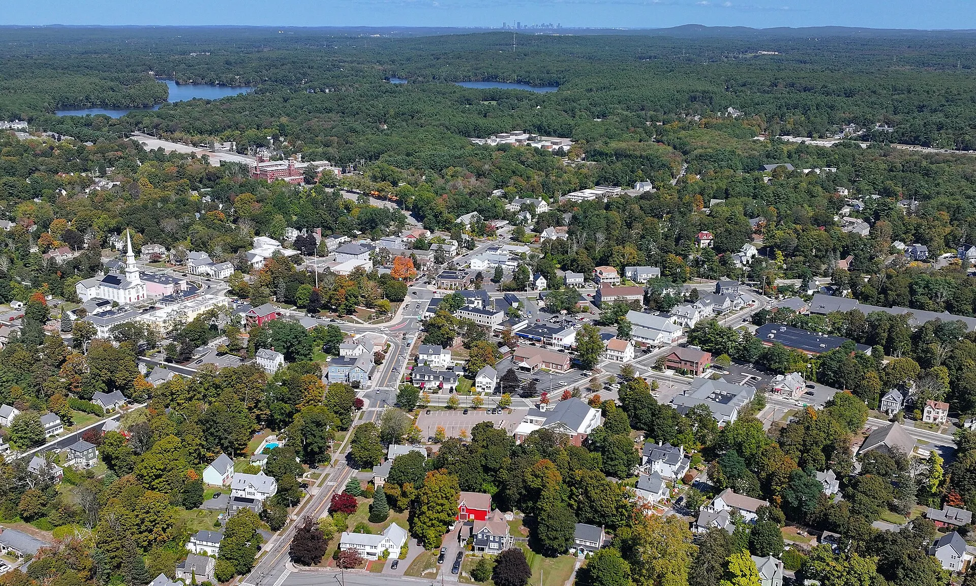 Aerial view of downtown Foxborough, Massachusetts, with the Boston skyline visible in the distance