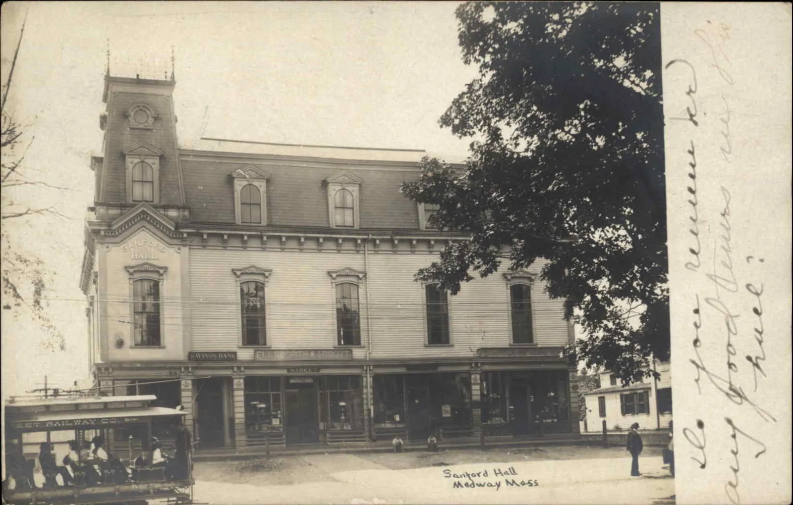 Divided back postcard of Sanford Hall in downtown Medway, Massachusetts, postmarked in 1908. At left is a streetcar of the Milford and Uxbridge Street Railway on its Medway-Milford line.