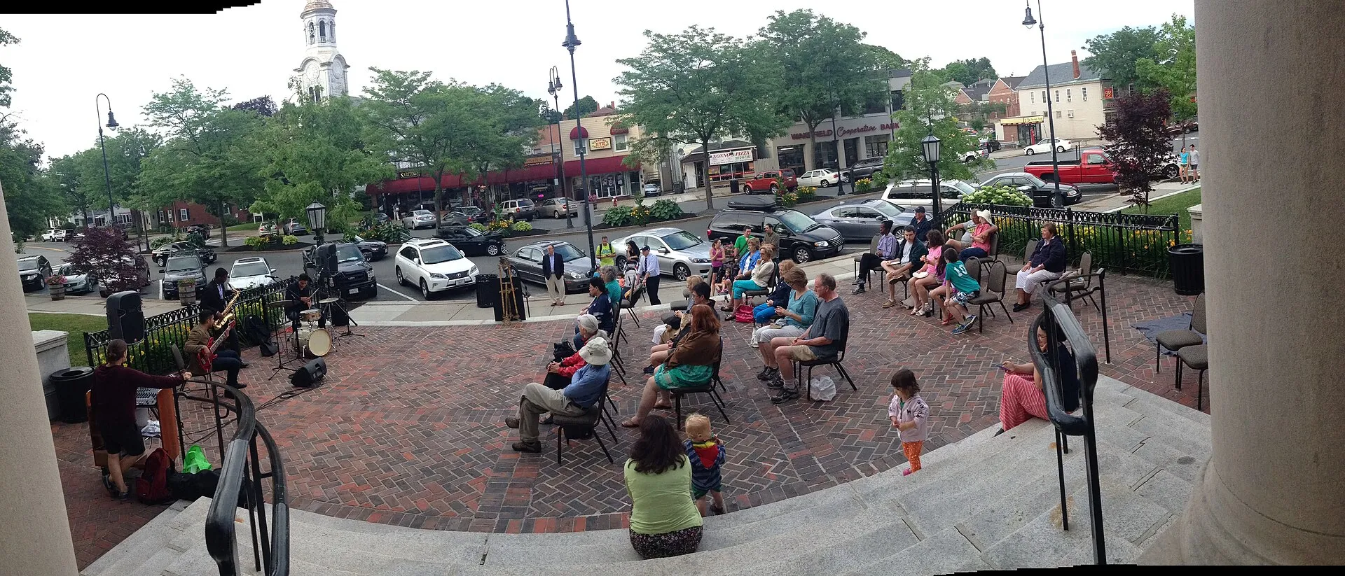 A jazz concert on the steps of Lucius Beebe Memorial Library in Wakefield, Massachusetts, on Thursday, June 26, 2014, showing a good view of Main Street in downtown Wakefield. Unitarian Universalist Church is visible without its spire at left.