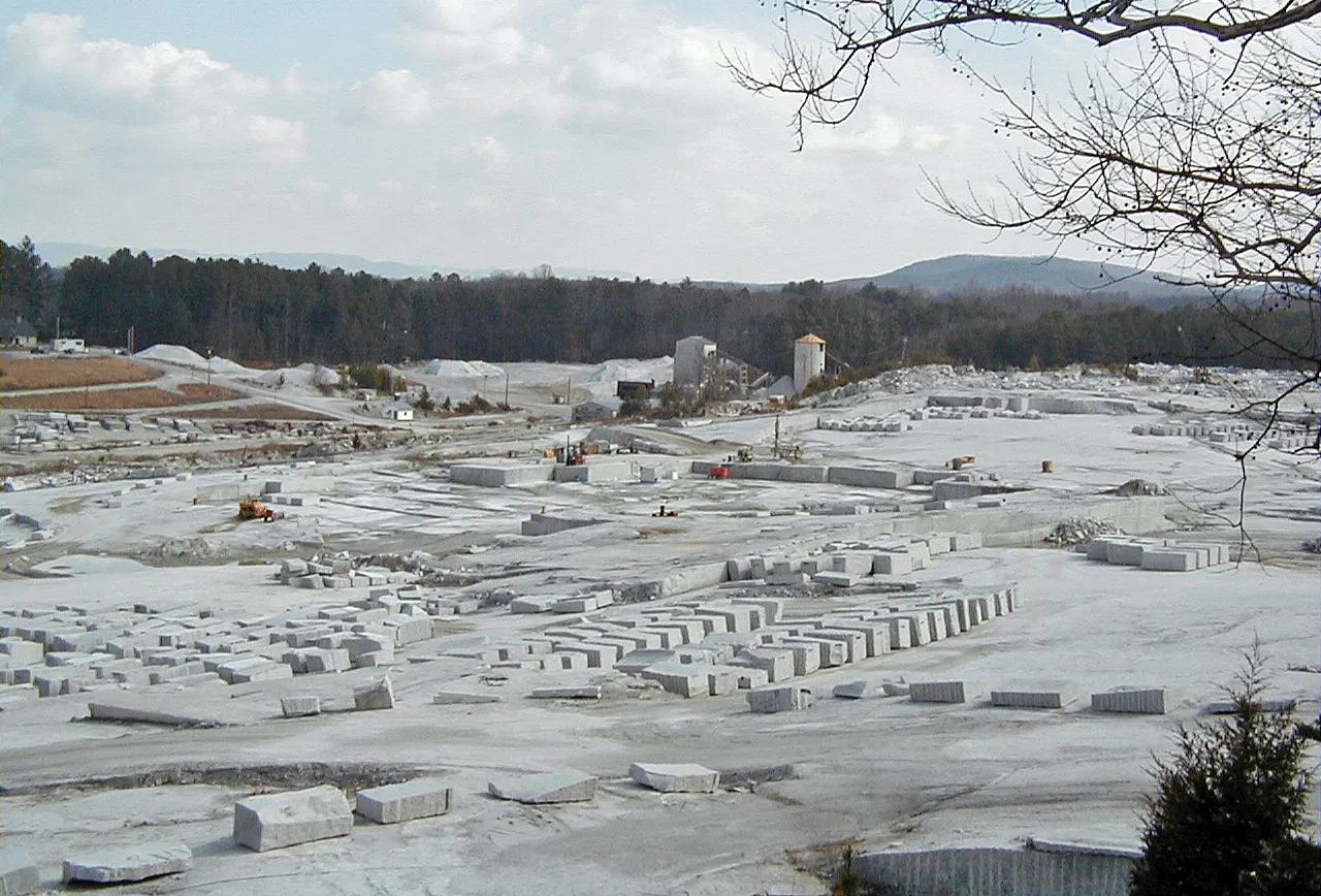 This quarry in North Carolina targets whitish-colored "Mt. Airy Granite" for the decorative stone trade. The rocks here are part of the Mt. Airy Pluton and range from monzogranites (= true...