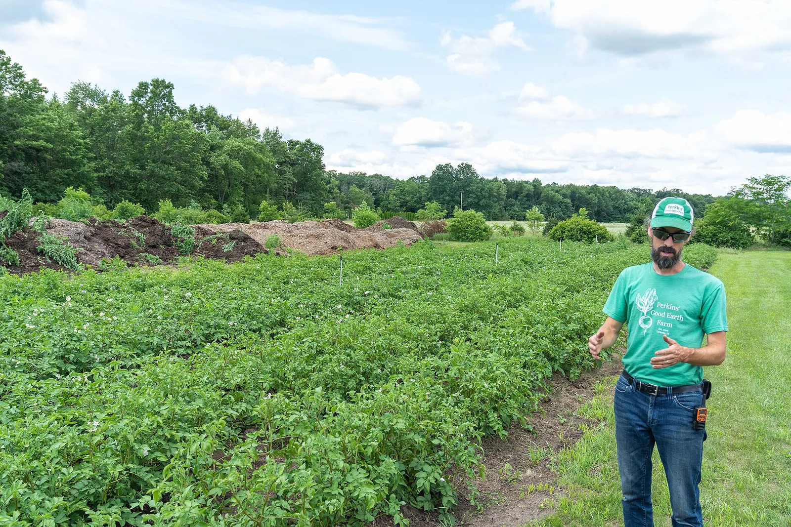 Dan Perkins, co-owner of Perkins' Good Earth Farm in DeMotte, Indiana, explains how the farm grows potatoes July 2, 2021. The farm supports more than 200 local families through its four season CSA program and they recently added food and beverage options as well as products by other local producers
