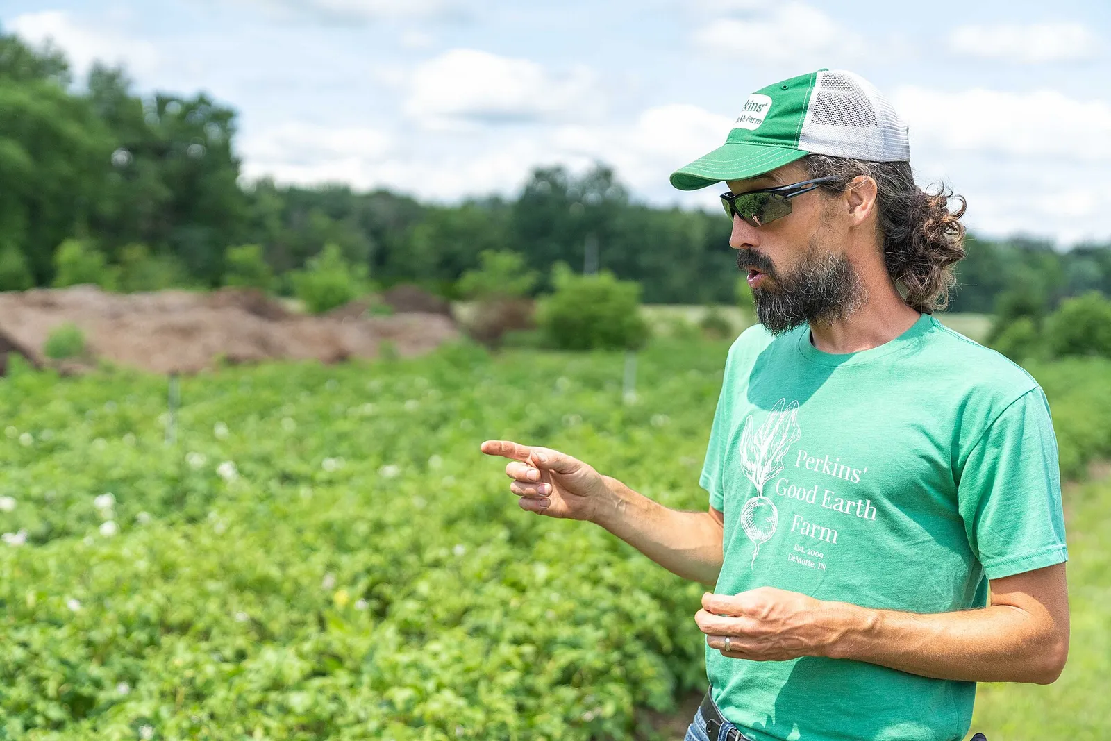 Dan Perkins, co-owner of Perkins' Good Earth Farm in DeMotte, Indiana, explains how the farm grows potatoes July 2, 2021. The farm supports more than 200 local families through its four season CSA program and they recently added food and beverage options as well as products by other local producers