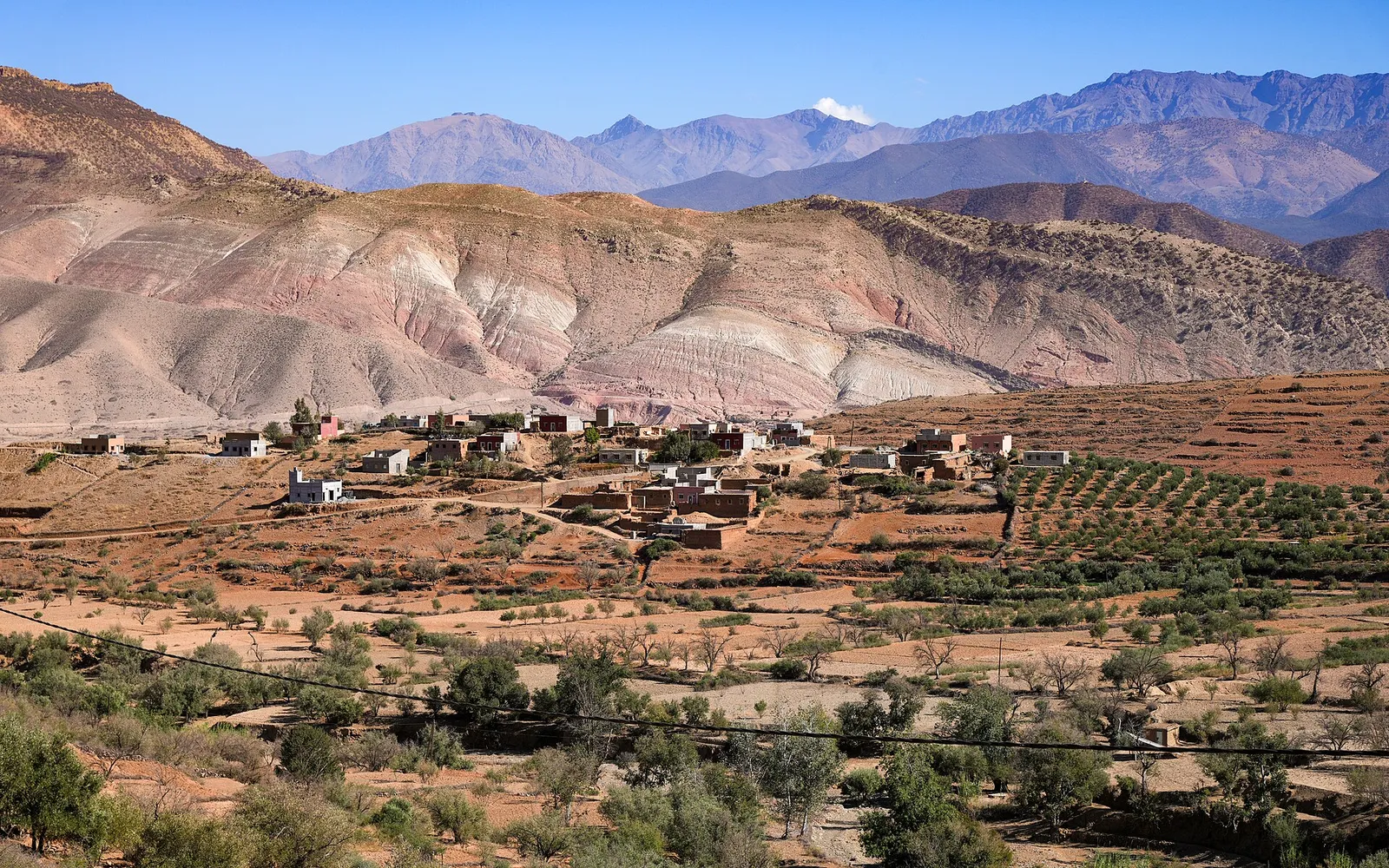 Arhbalou village, trees in foreground, viewed from RR209, backdrop High Atlas Mountains, Al Haouz province, Morocco
