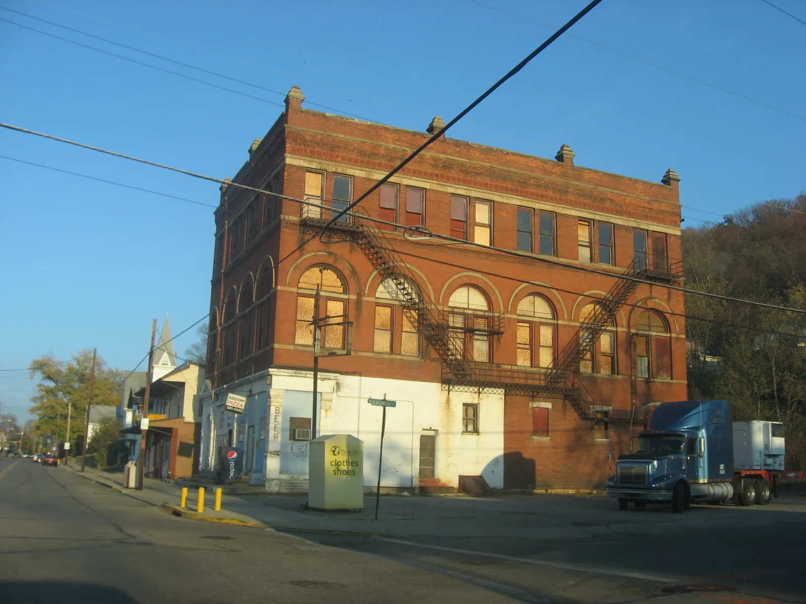 Eastern side of the building on the northwestern corner of the intersection of Main and Church Streets in downtown Addyston, Ohio, United States. This building and those around it are part of a historic district, the Vi