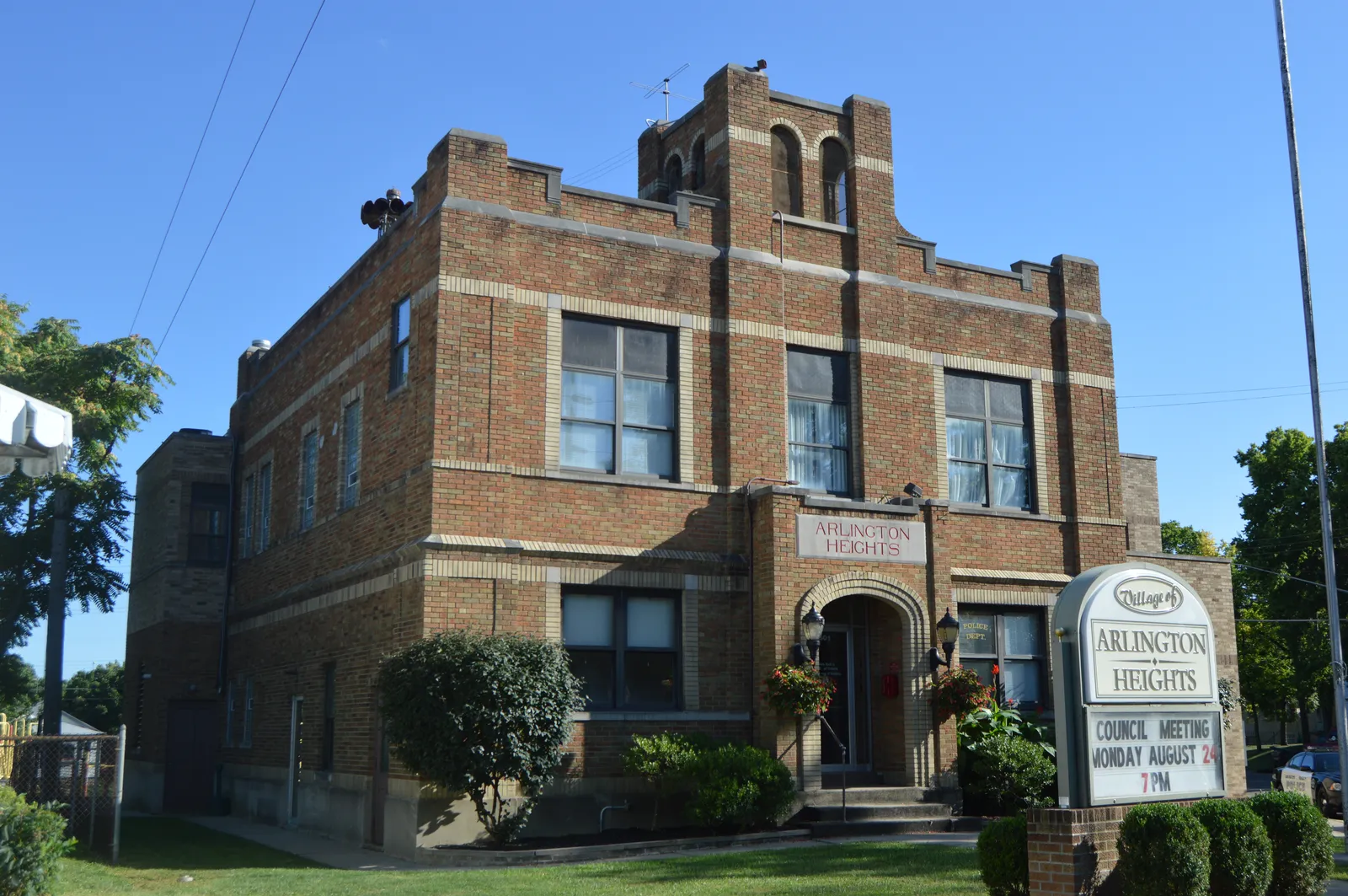 Front and northeastern side of Village Hall in Arlington Heights, Ohio, United States, located at the junction of Erkenbrecher and Elliott Avenues.