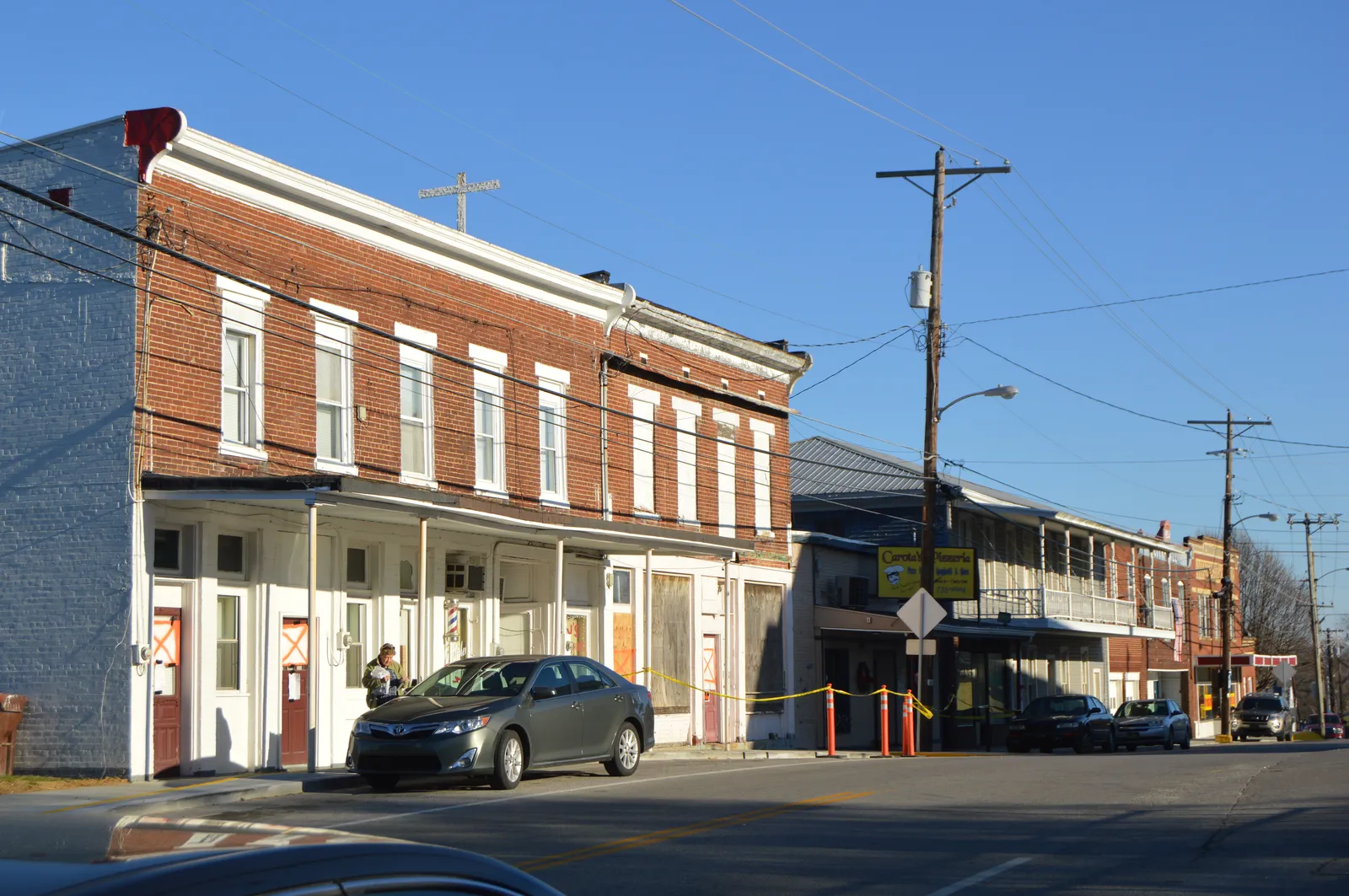 Buildings on the northeastern side of Miami Street (Kentucky Route 1159) at the Locust Street intersection in central Brooksville, Kentucky, United States.