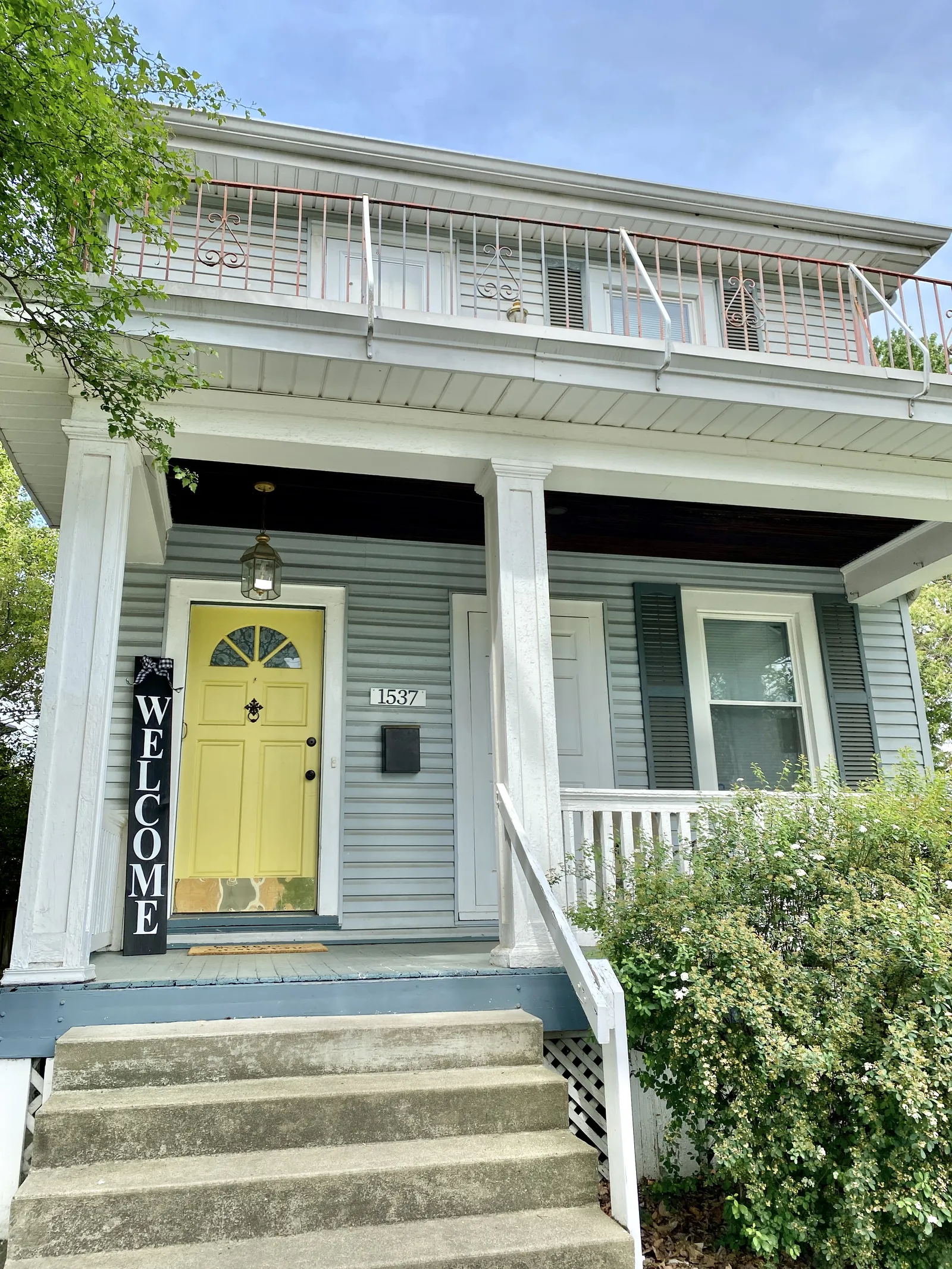 Built circa 1926, this wood-frame duplex with a large welcome sign on the front porch next to a tastefully painted door stands on Eastern Avenue in Covington’s Austinburg neighborhood, and is a contributing structure in