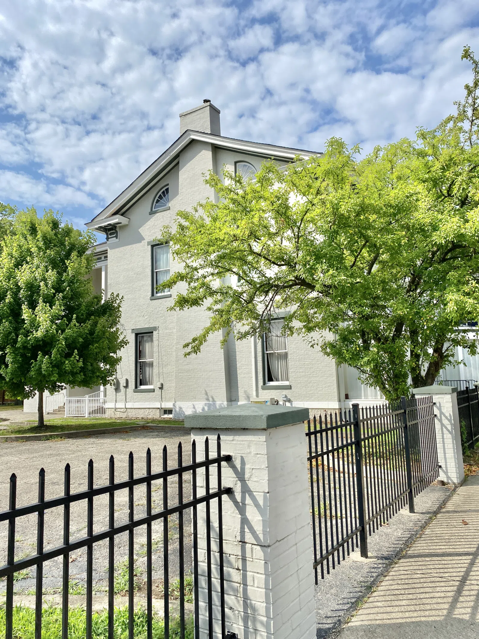 Built in 1870, this Italianate-style house was constructed for George Barnitz, a local businessman. The building features a painted brick exterior, two-over-two double-hung windows with decorative hoods, a cornice with b