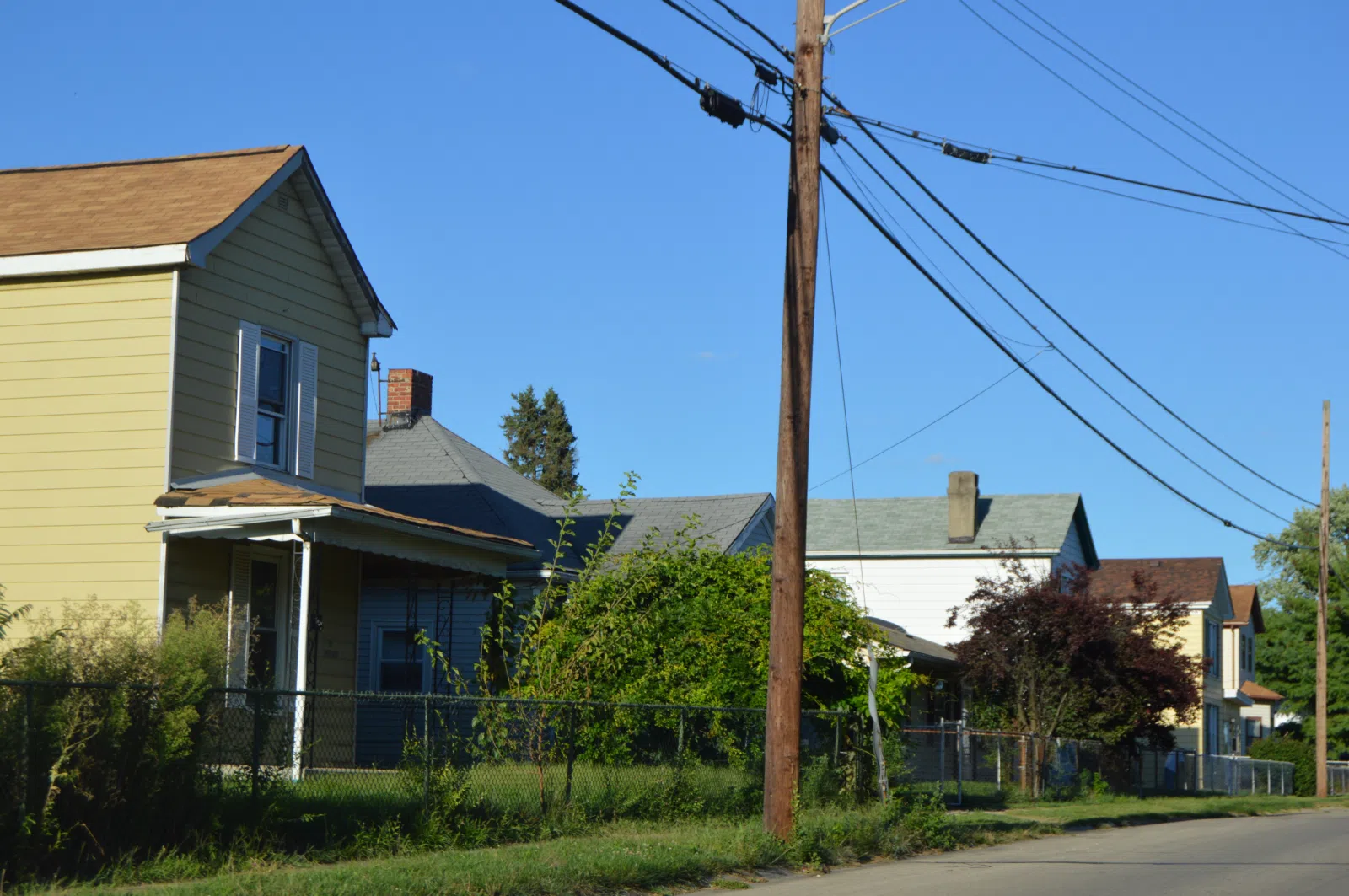 Houses on the northern side of Augspurger Avenue at the Highland Avenue intersection in New Miami, Ohio, United States.