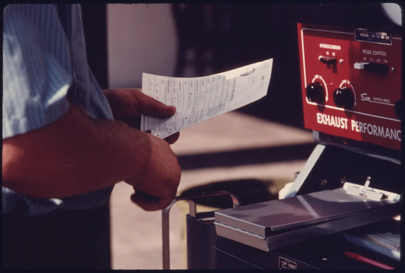 File:CLOSEUP OF AN EMPLOYEE PUNCHING AN AUTO EMISSION INSPECTION SHEET AT A HAMILTON COUNTY TEST STATION IN NEWTOWN, OHIO.... - NARA - 557829.jpg
