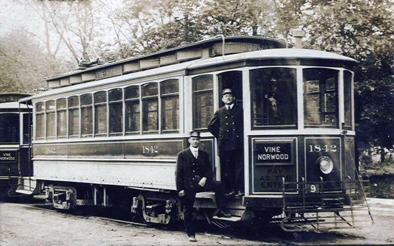 Two conductors stand beside a Cincinnati, Ohio streetcar on the 9 Vine-Norwood line c. 1910. The car traveled from 6th & Walnut downtown to Montgomery & Sherman in Norwood, Ohio.