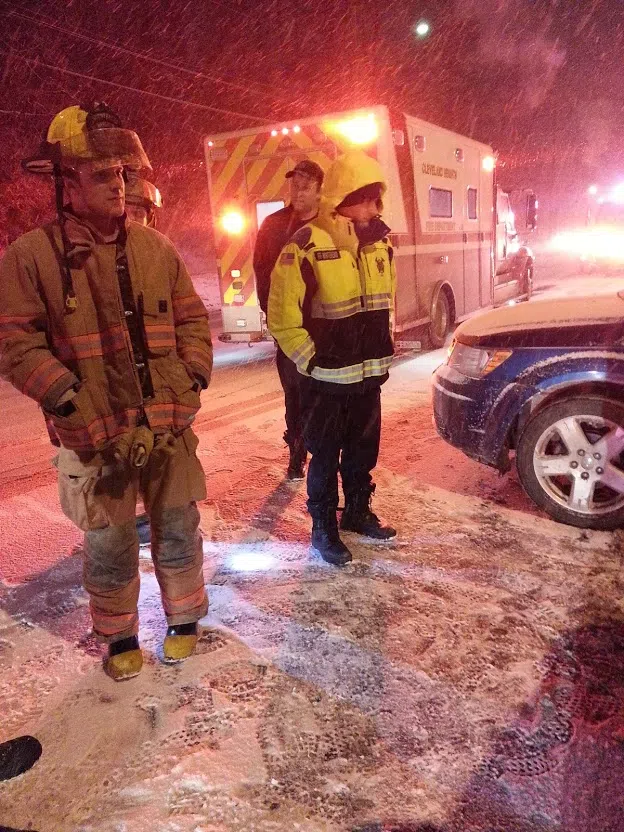 A firefighter (left) and two paramedics with the Cleveland Heights Cleveland Heights Fire/EMS Division respond to a traffic accident in the snow on Mayfield Road in…