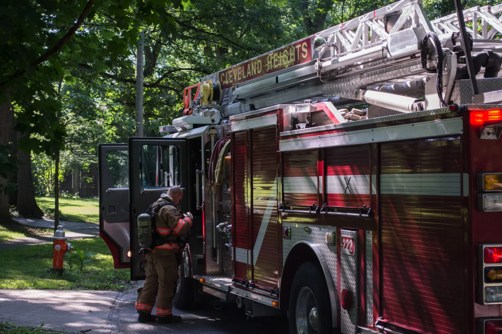 A firefighter stores his gear aboard Ladder 222, a fire ladder truck belonging to the Cleveland Heights Fire Department in Cleveland Heights, Ohio. Ladder 222 is an…