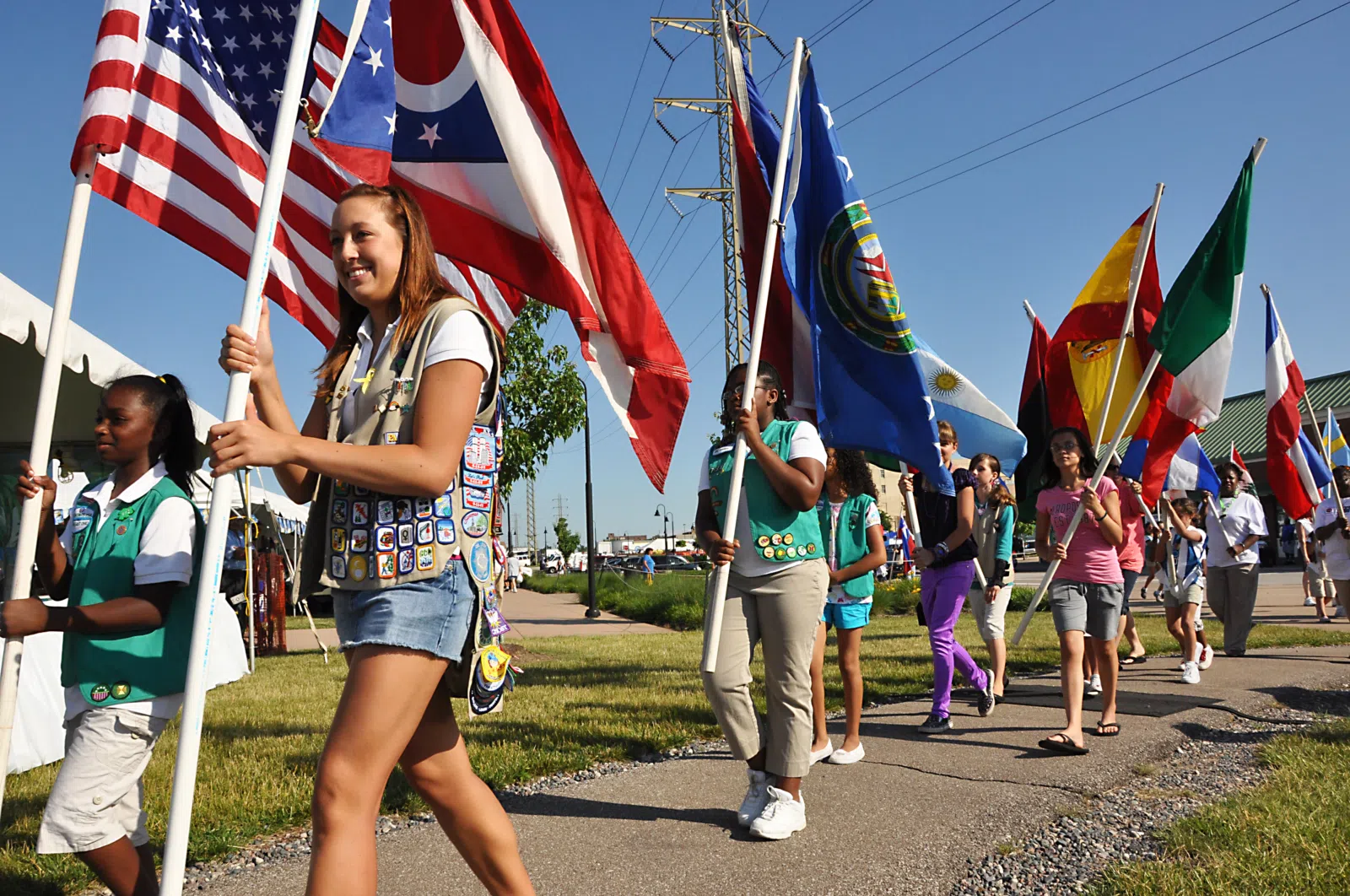 Girl Scouts from Lighthouse Service Unit of Girl Scouts of Northeast Ohio carry the international flags into Black River Landing Friday night to officially kick off the…
