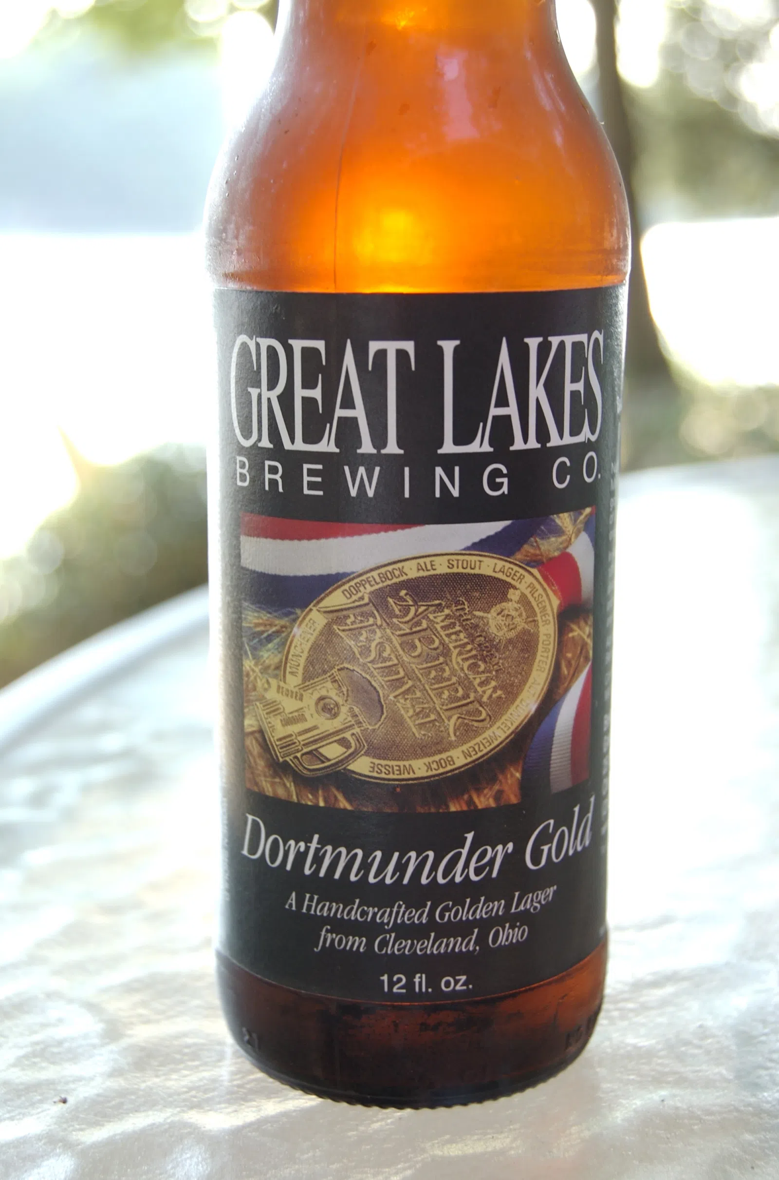 A bottle of Dortmunder Gold pale lager beer, produced by Great Lakes Brewing Company of Cleveland , Ohio , United States . Photo taken at Lake Roaming Rock, near Roaming…