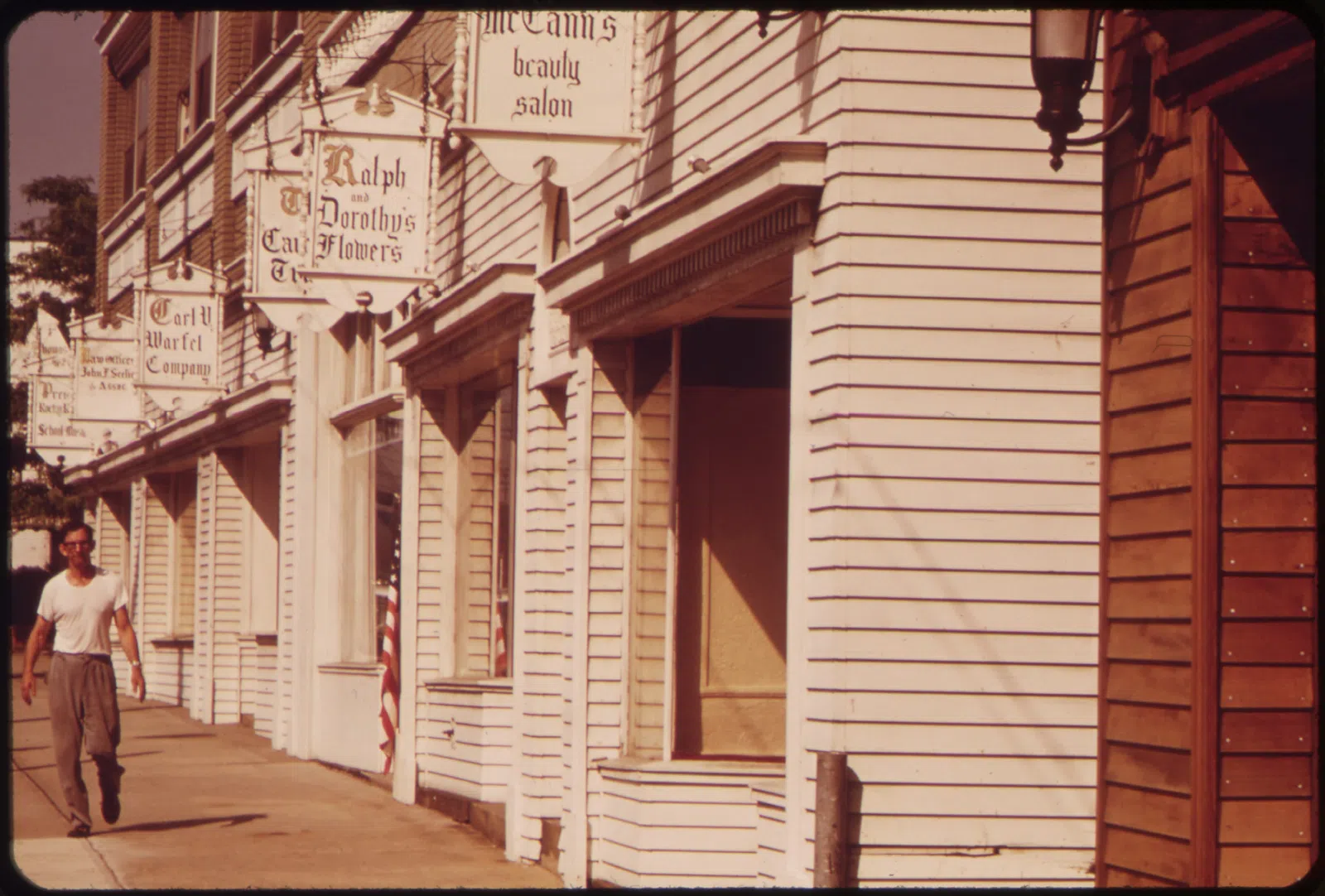 ATTRACTIVE STOREFRONTS AND SIGNS GIVE NEW LIFE TO DECAYING BUSINESS SECTION OF SUBURBAN ROCKY RIVER - NARA - 550114.jpg