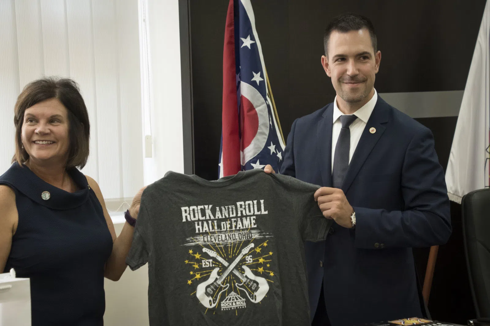 South Euclid, Ohio Mayor Georgine Welo (left) presents a Rock and Roll Hall of Fame T-shirt to Kraljevo, Serbia Mayor Predrag Terzić during the signing of a memorandum…