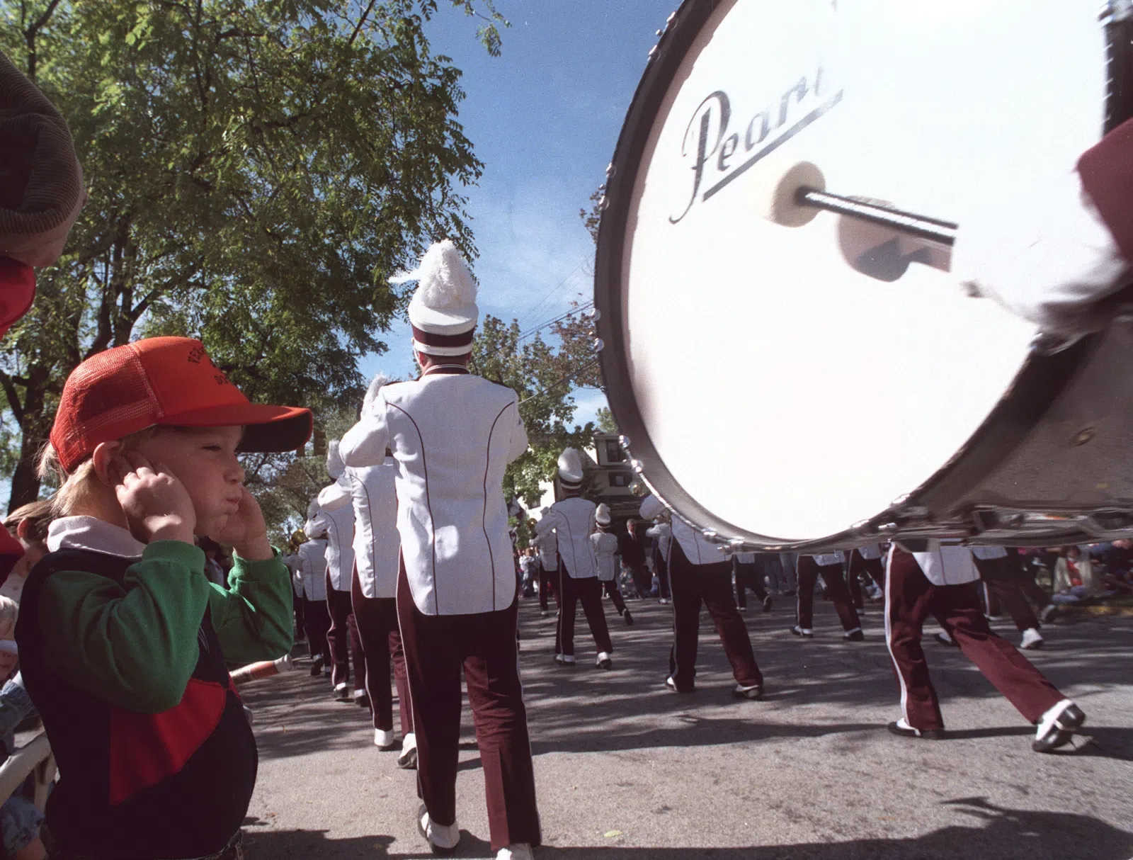 Zach Lehner plugs his ears as a marching band passes by, at the Woolly Bear Festival in Vermilion Ohio.