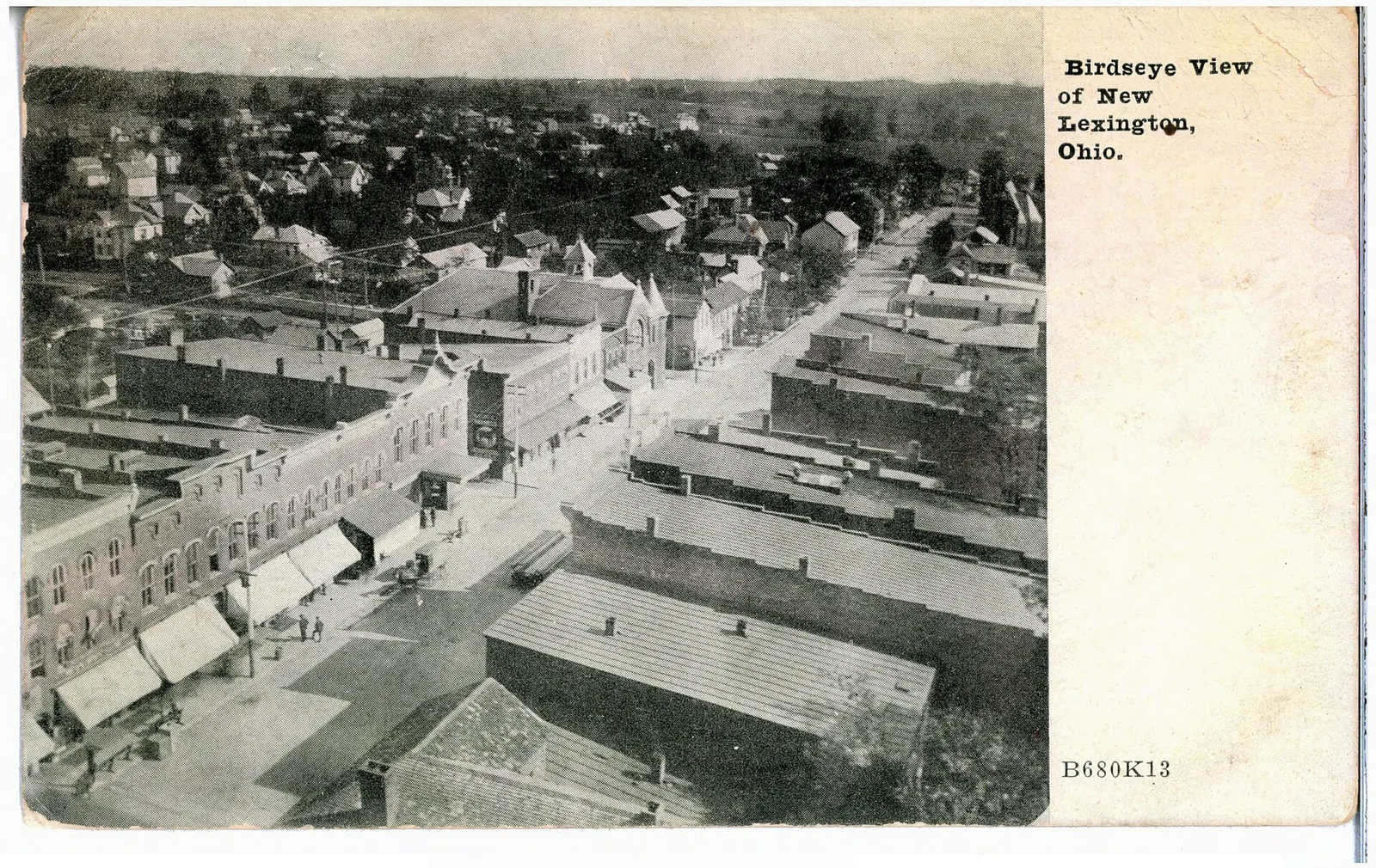 Tinted photograph looking over the main street and part of the residential area of town.