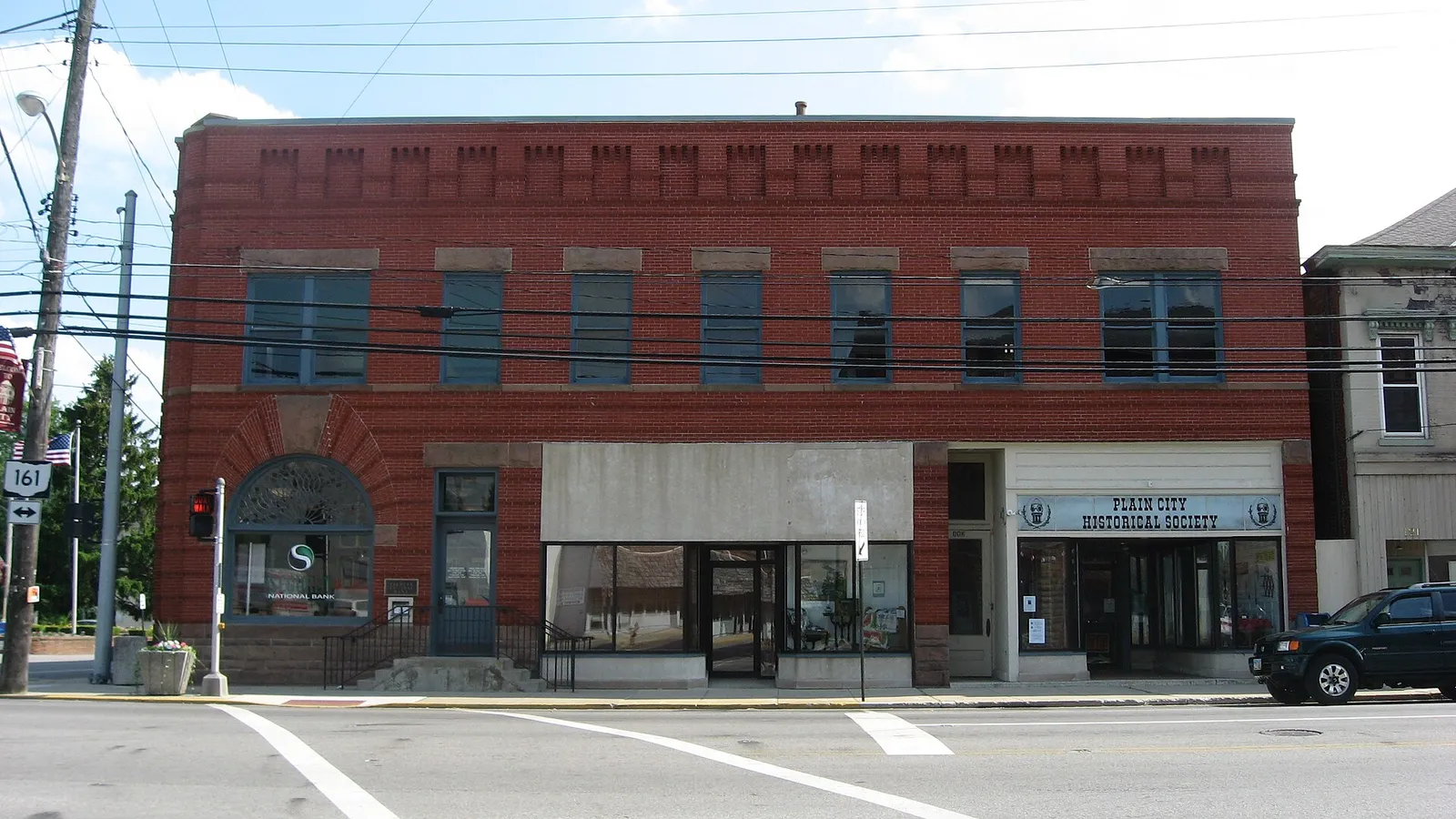 Front of the Farmers National Bank, located on the southwestern corner of the intersection of Main (State Route 161) and Chillicothe Streets in downtown Plain C