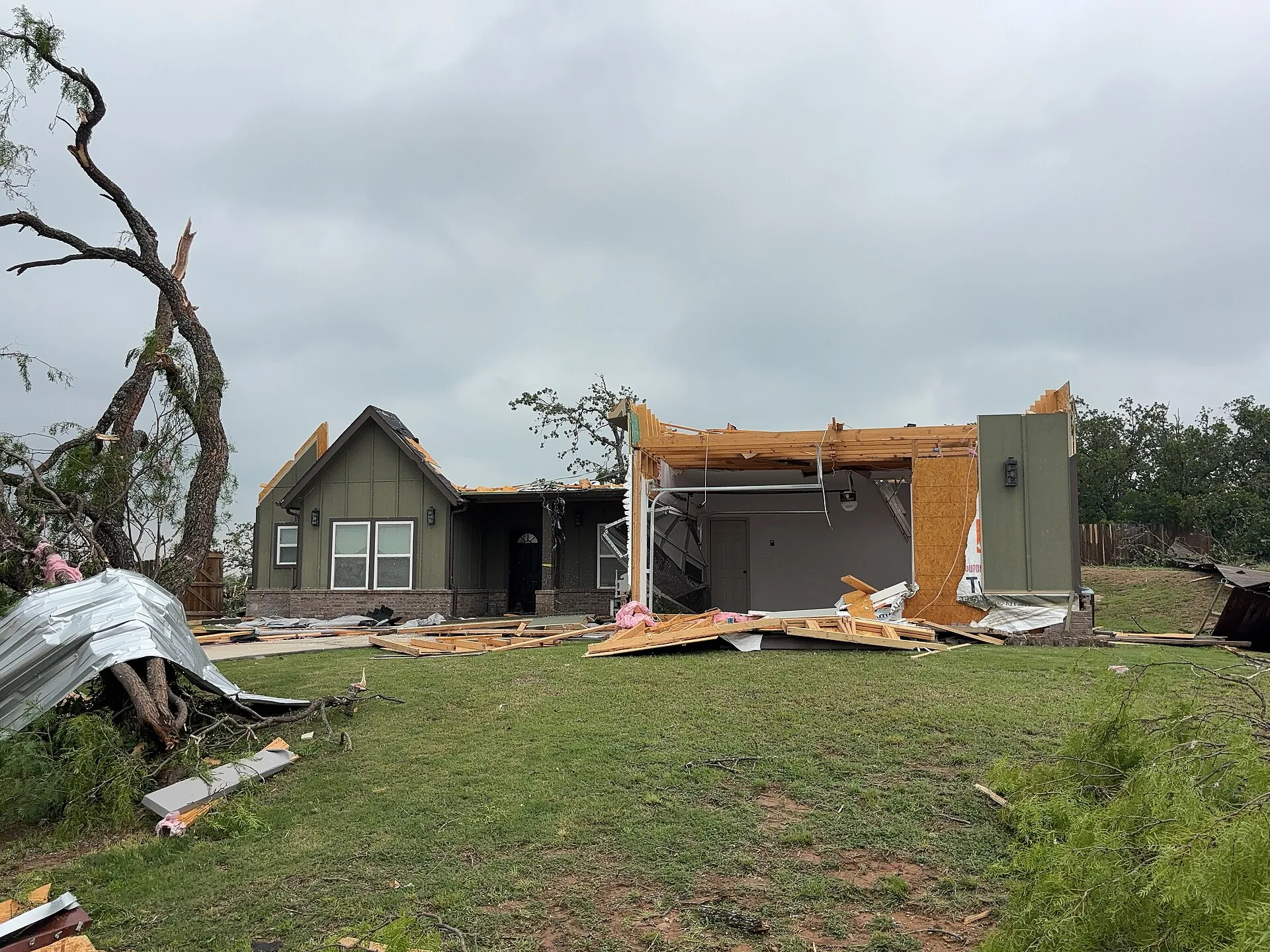 A home with most of its roof removed by an EF2 tornado in Runaway Bay, Texas (2023).