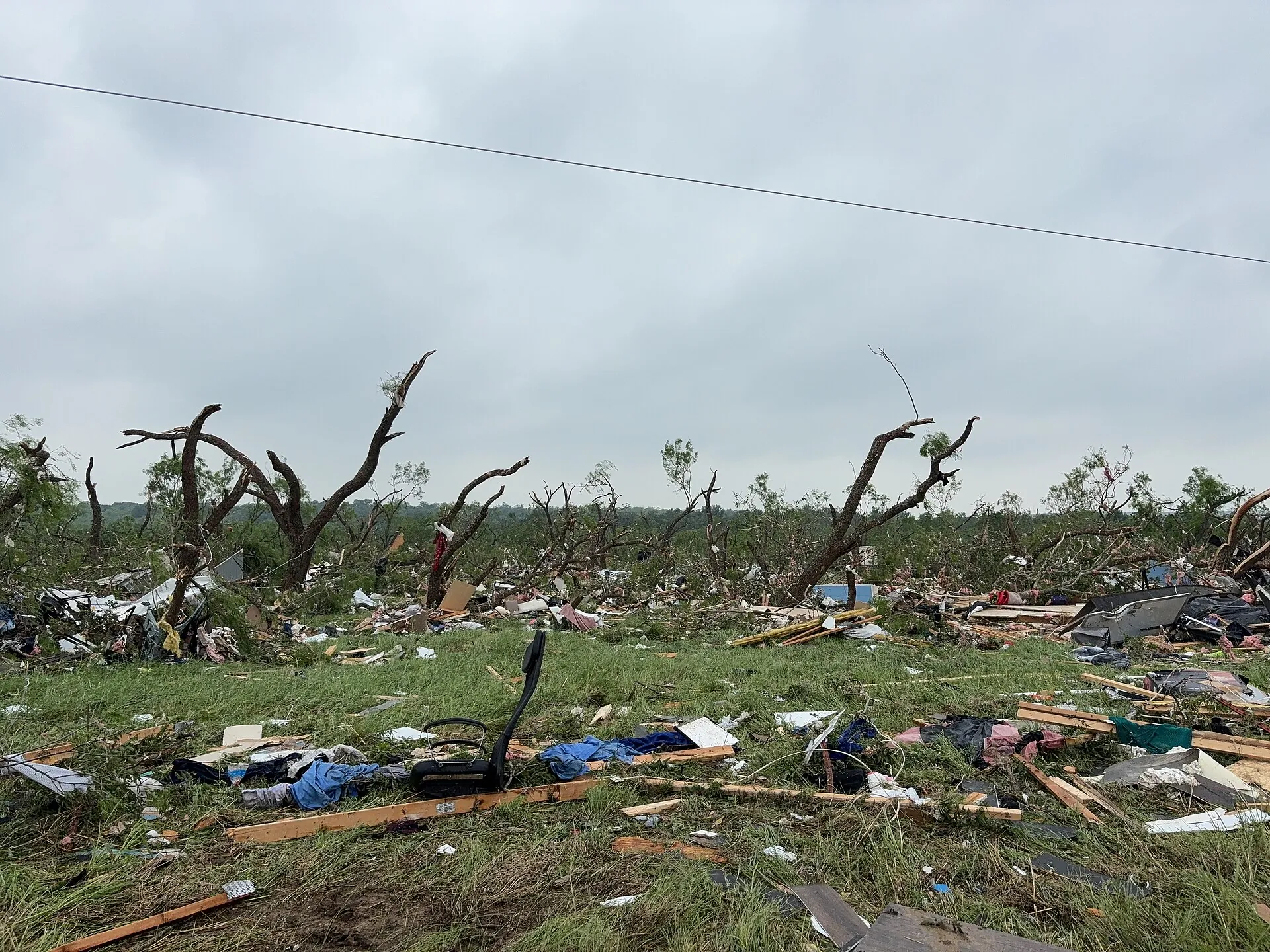 Debris of a mobile home blown into trees after an EF2 tornado in Runaway Bay, Texas (2023).