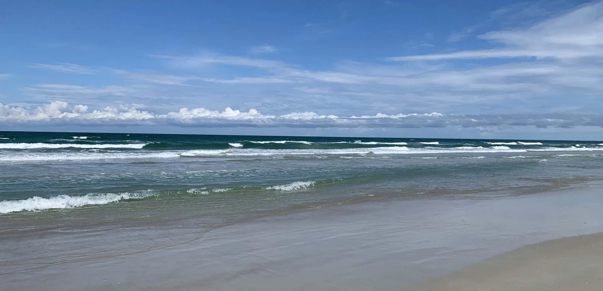 Surf at New Smyrna Beach, known for its bodysurfing conditions.